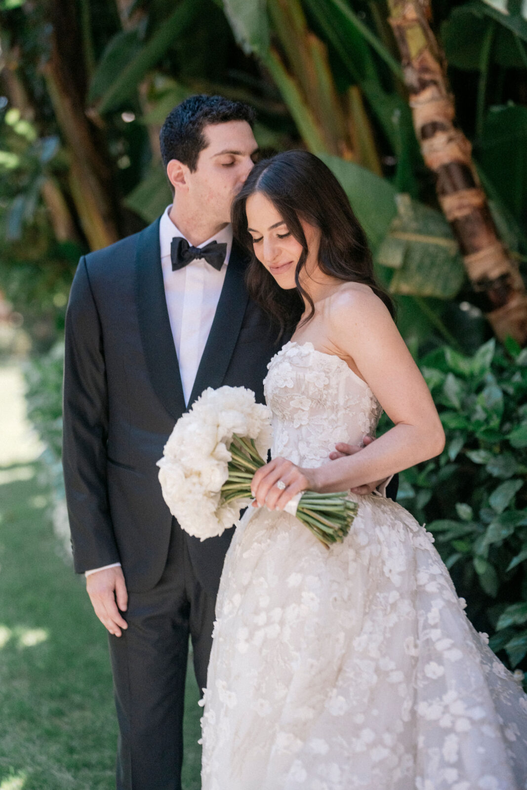 Groom kissing forehead