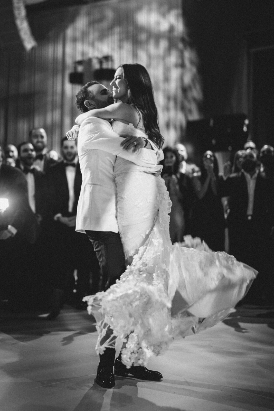 bride and groom dancing and hugging