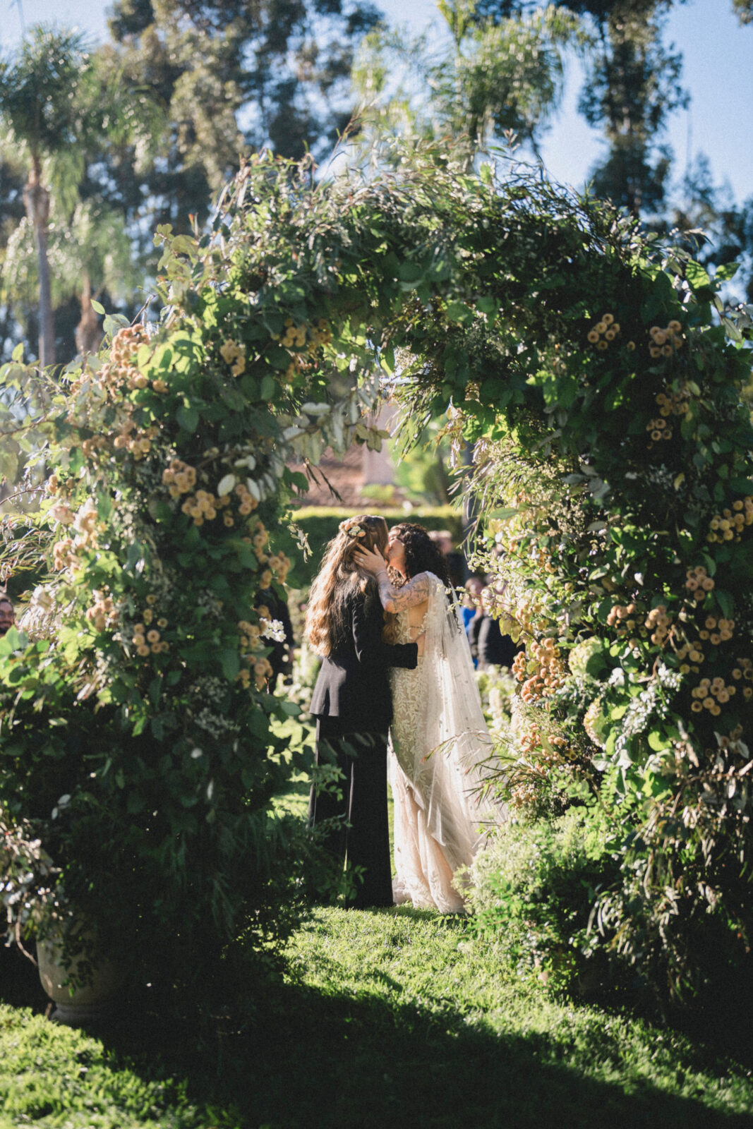 bride and groom kissing at the altar