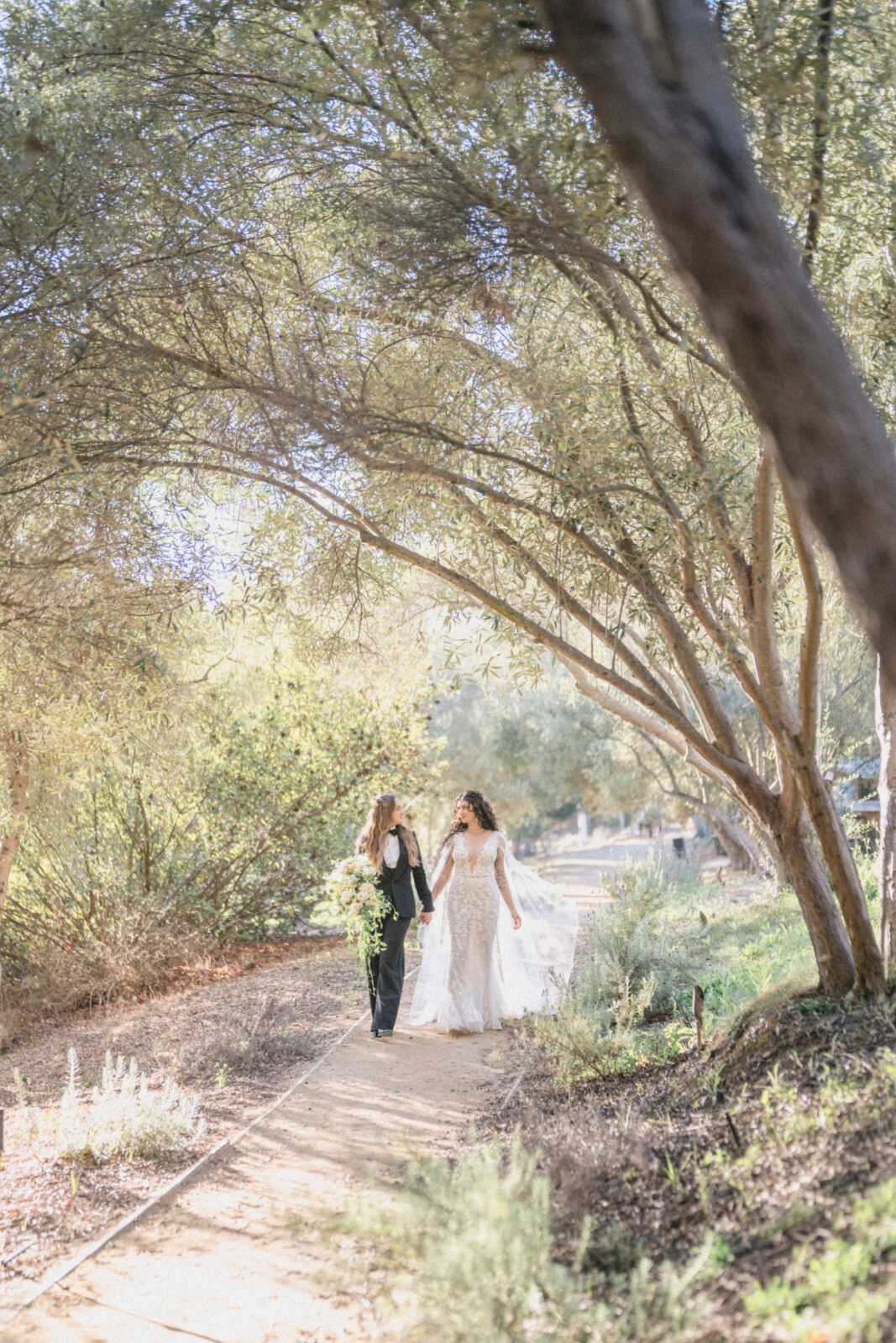 bride and groom walking  while holding their hands