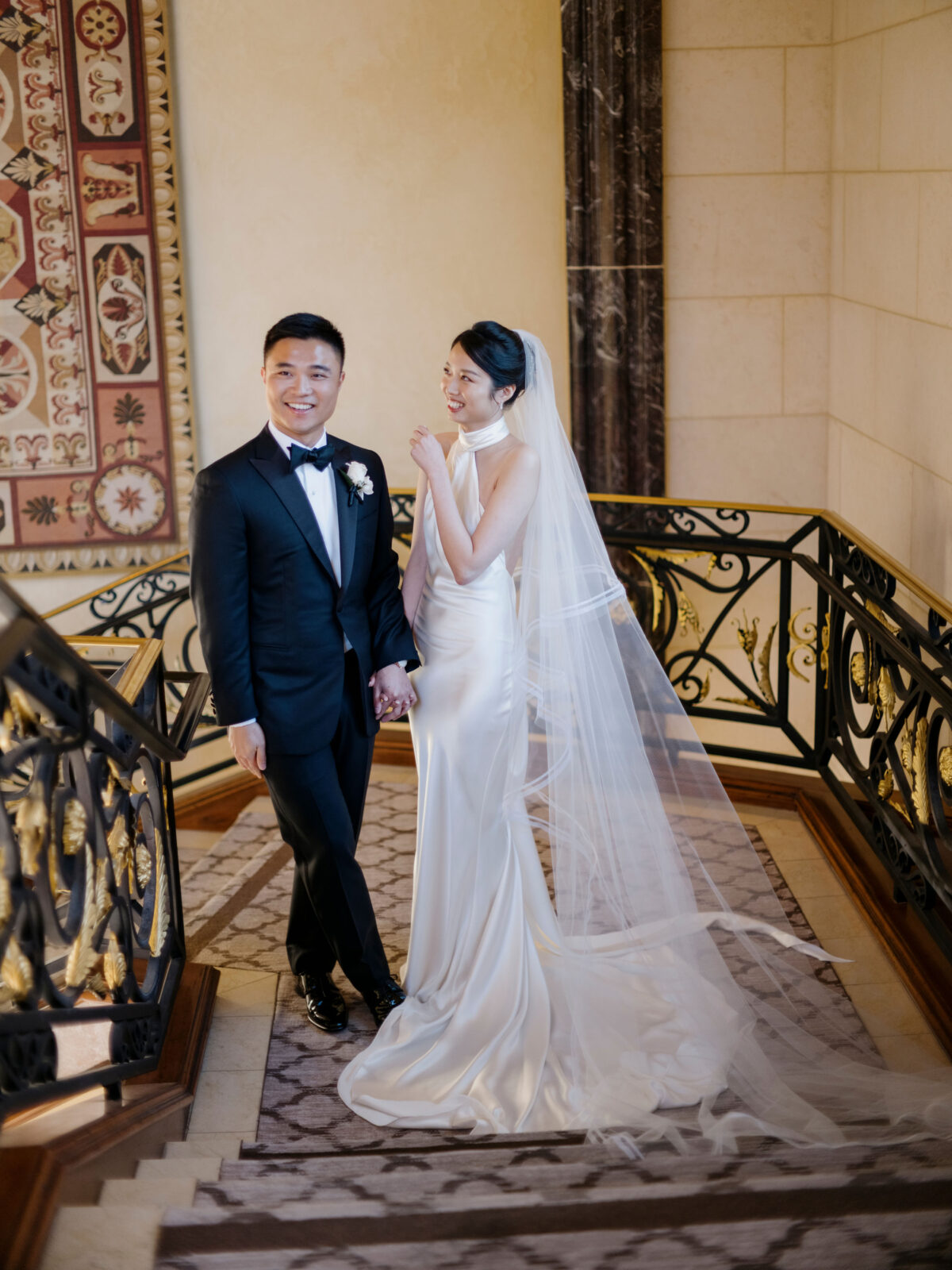 bride and groom smiling at each other