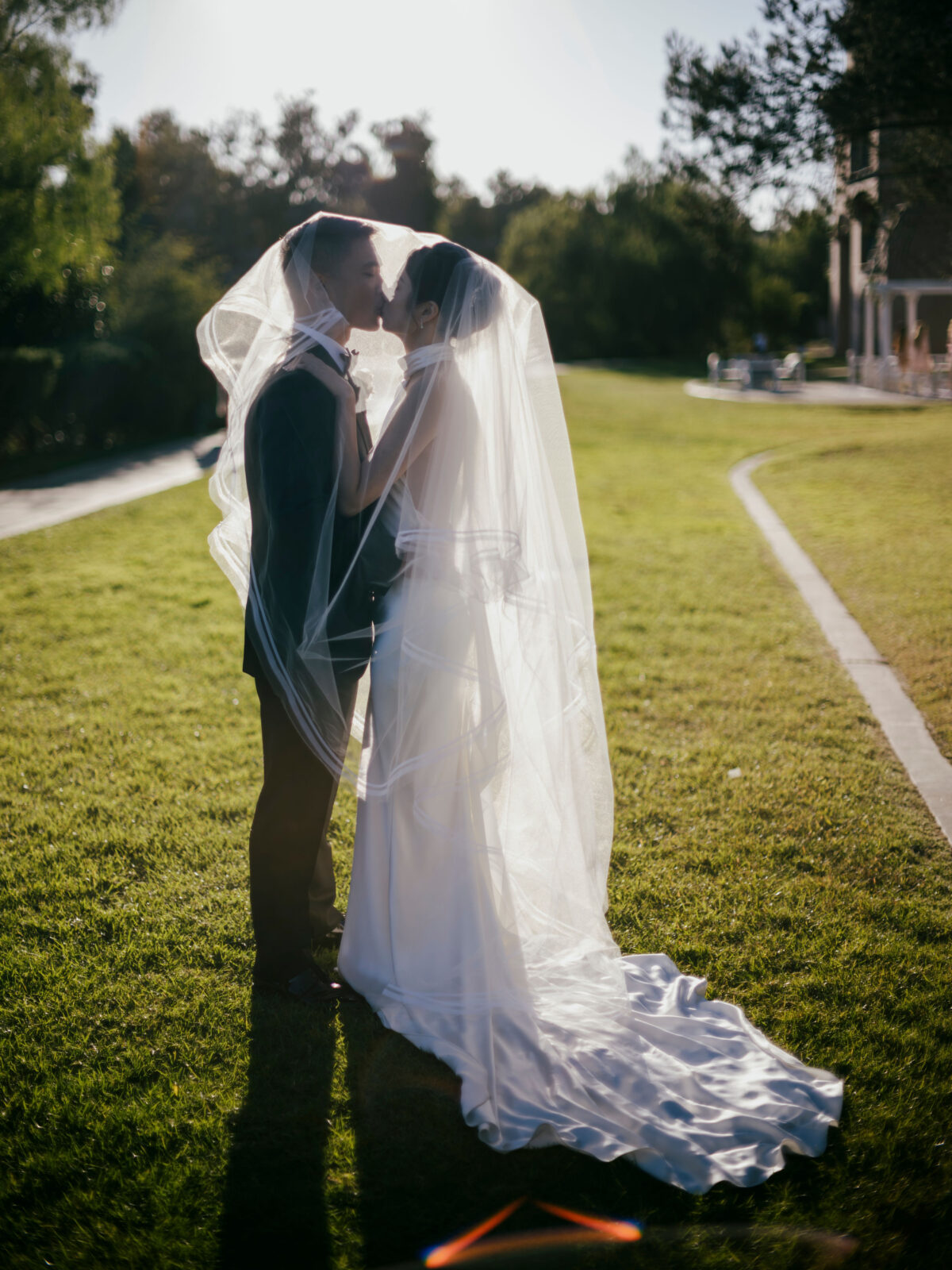 bride and groom kissing under the veil 