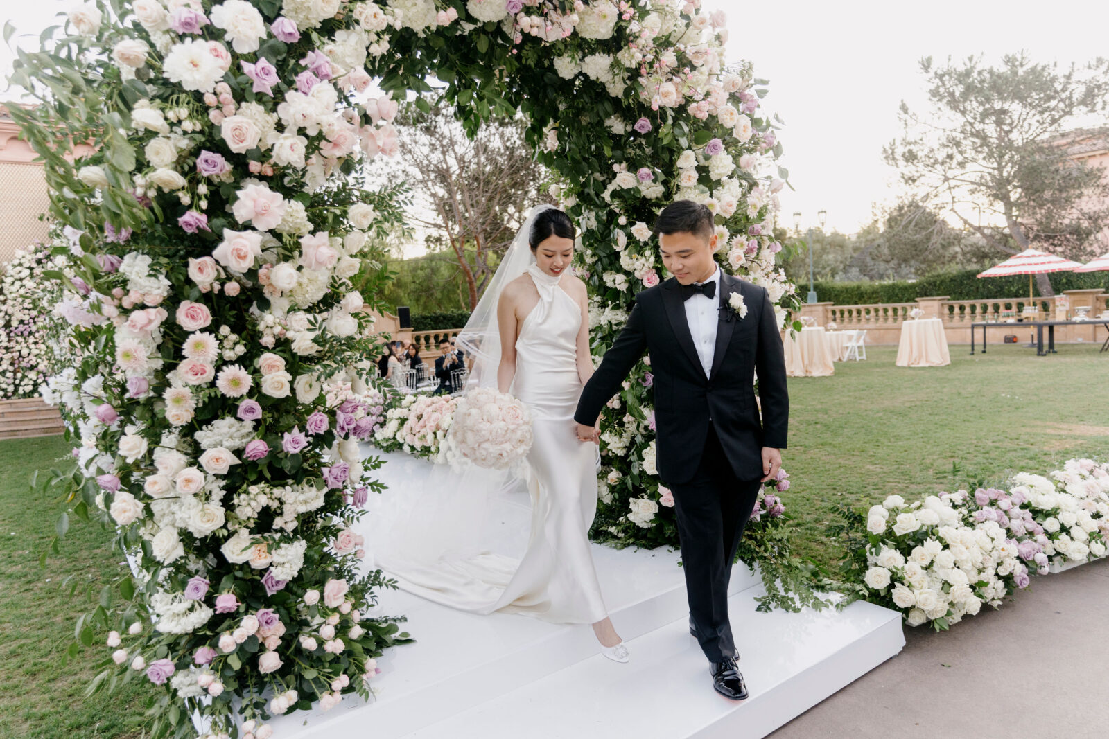 bride and groom holding hands