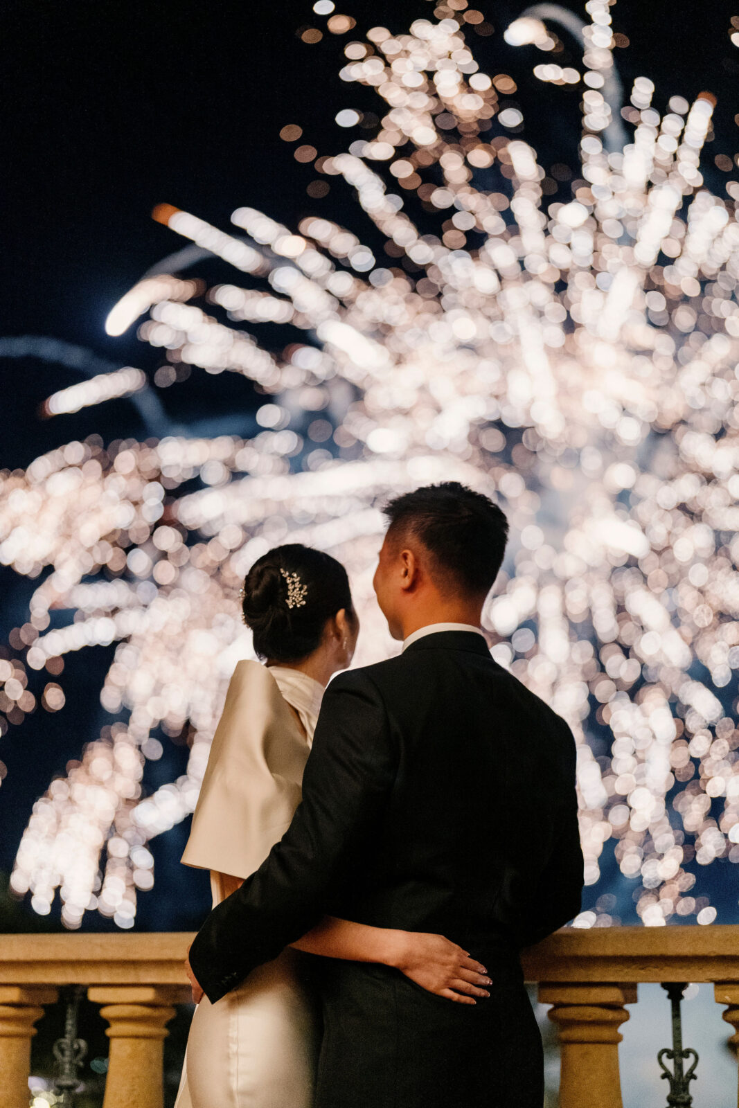 bride and groom looking at the fireworks