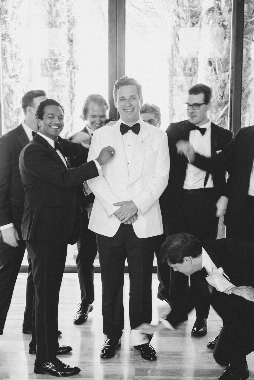 groom and his groomsmen smiling