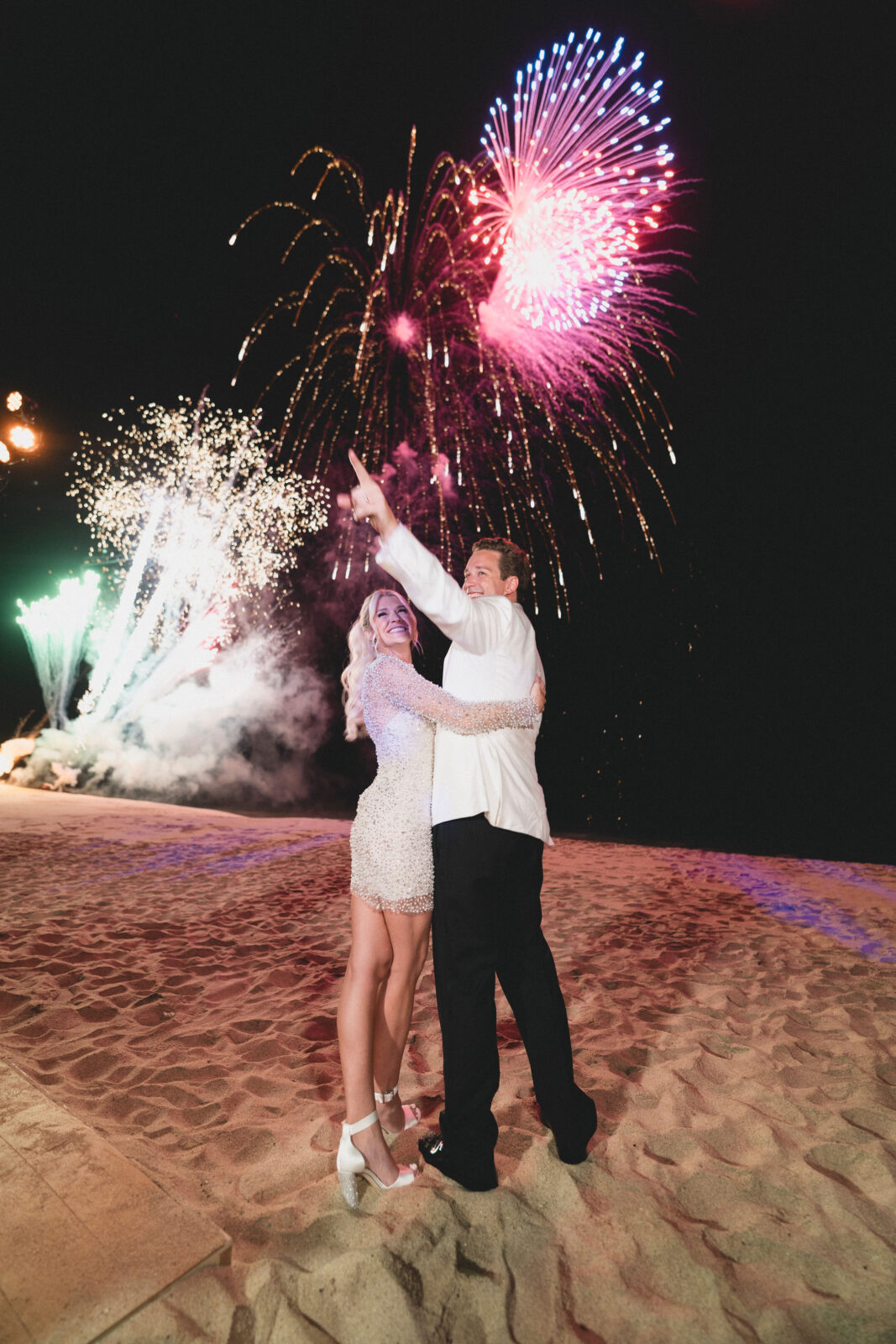 husband and wife happily looking at the fireworks