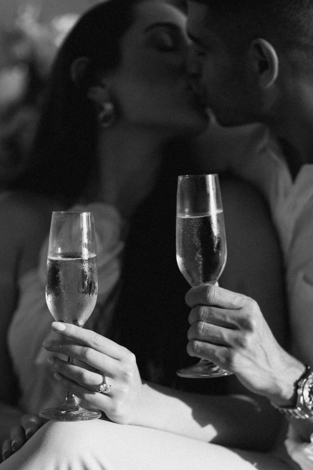 man and woman kissing in black and white