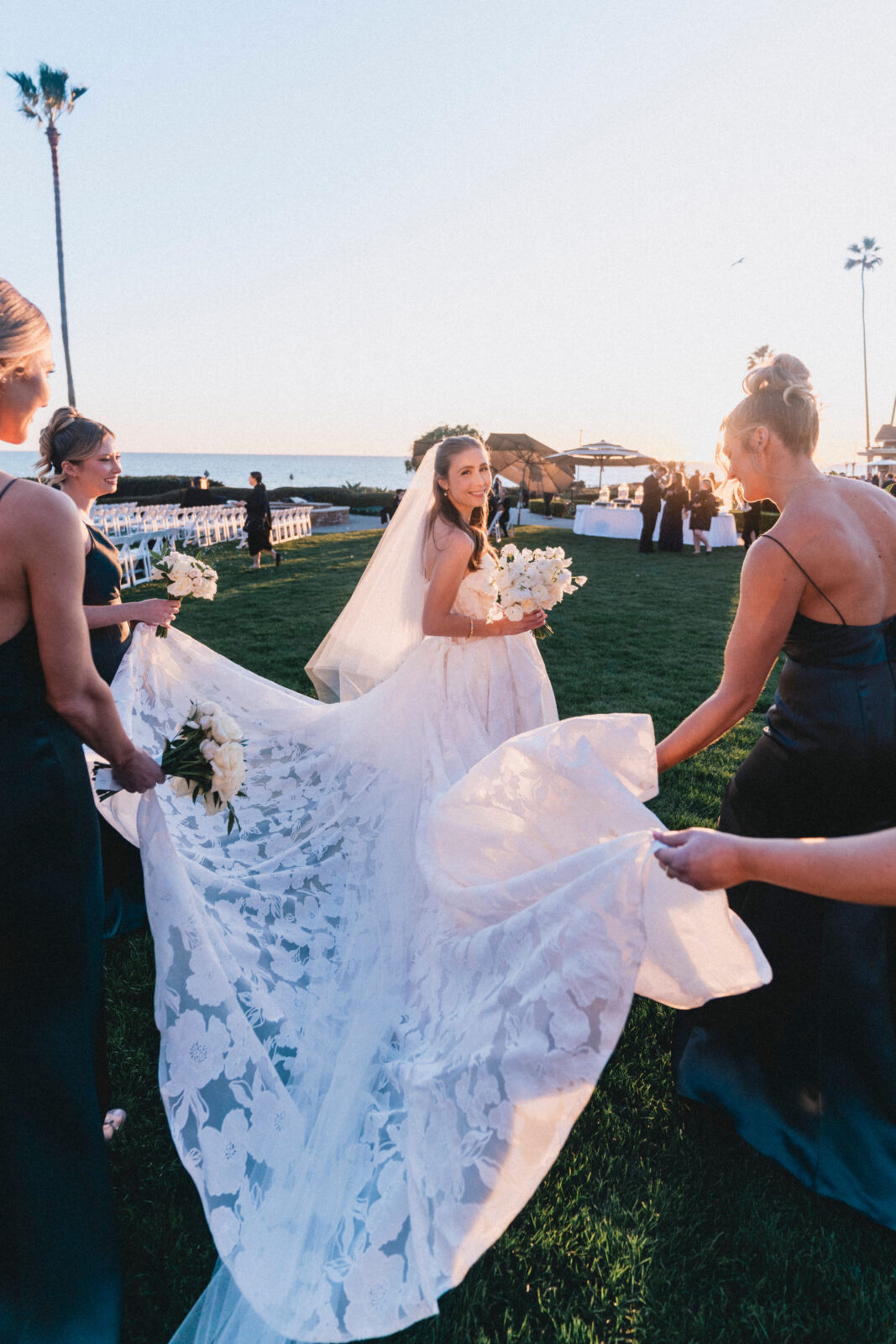 bride and bridesmaids holding the wedding dress