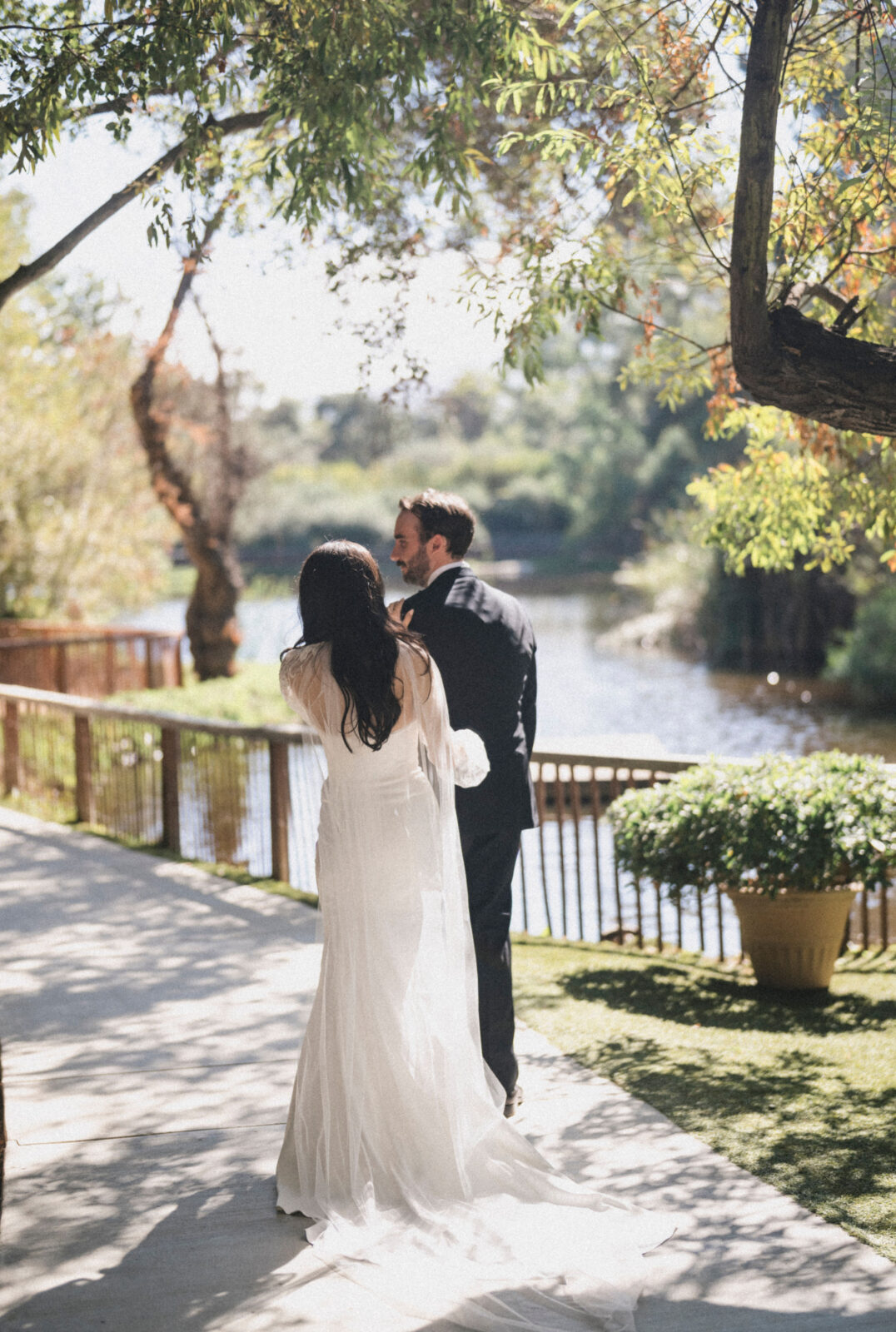 bride and groom looking at each other while walking