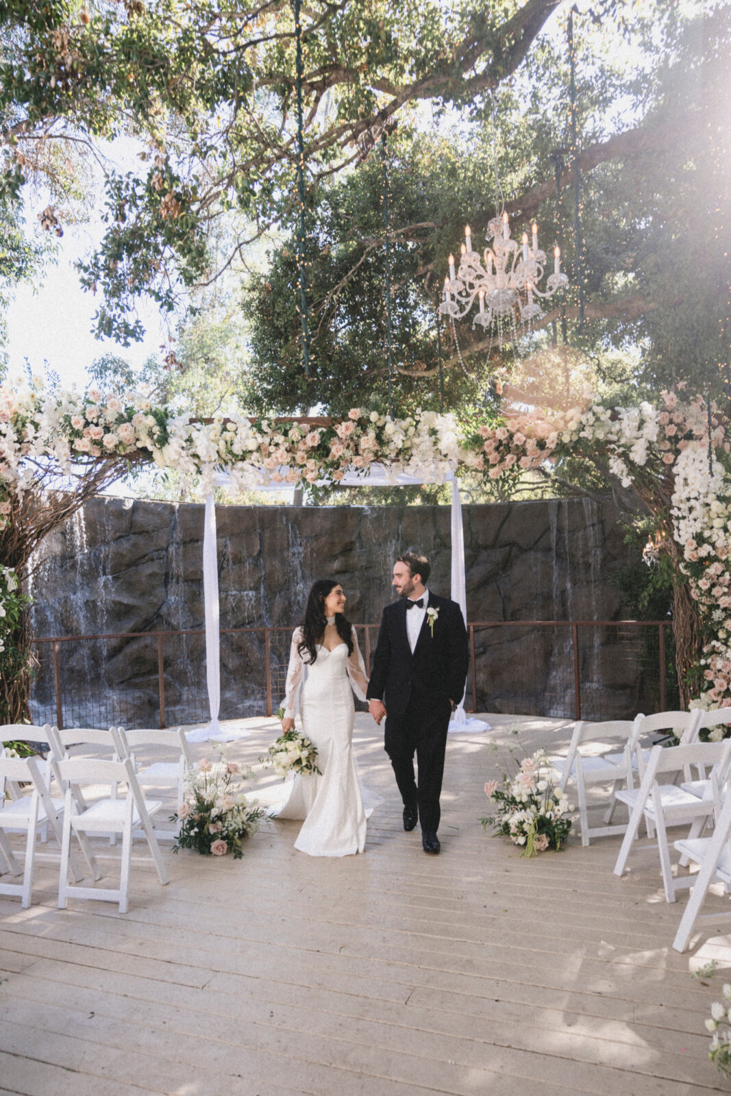 bride and groom holding hands