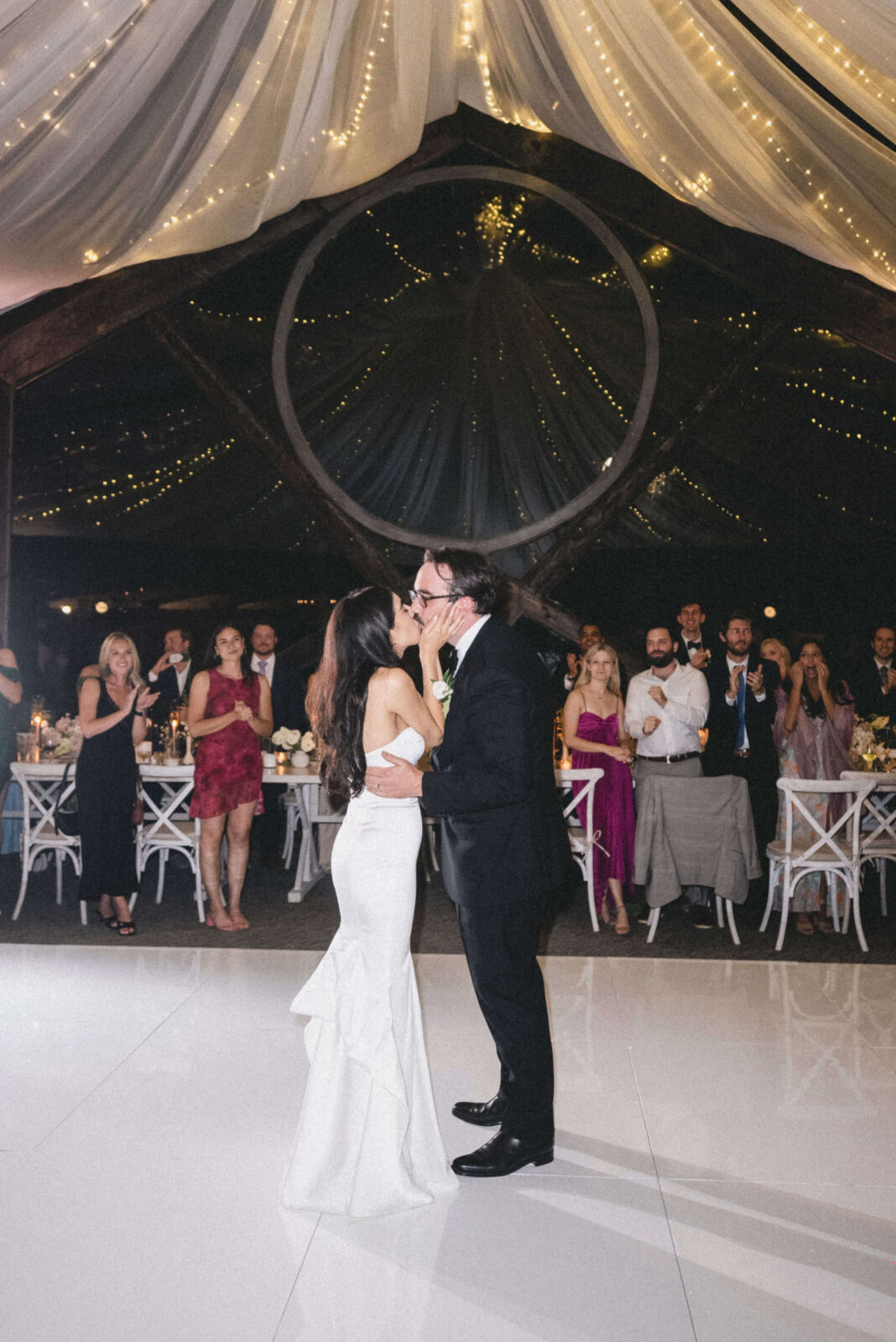 bride and groom kissing on the dance floor