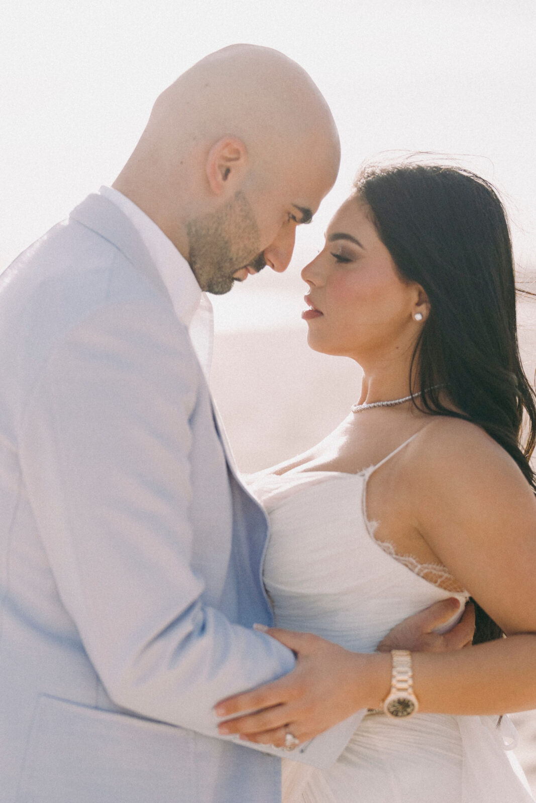 bride and groom staring at each other 