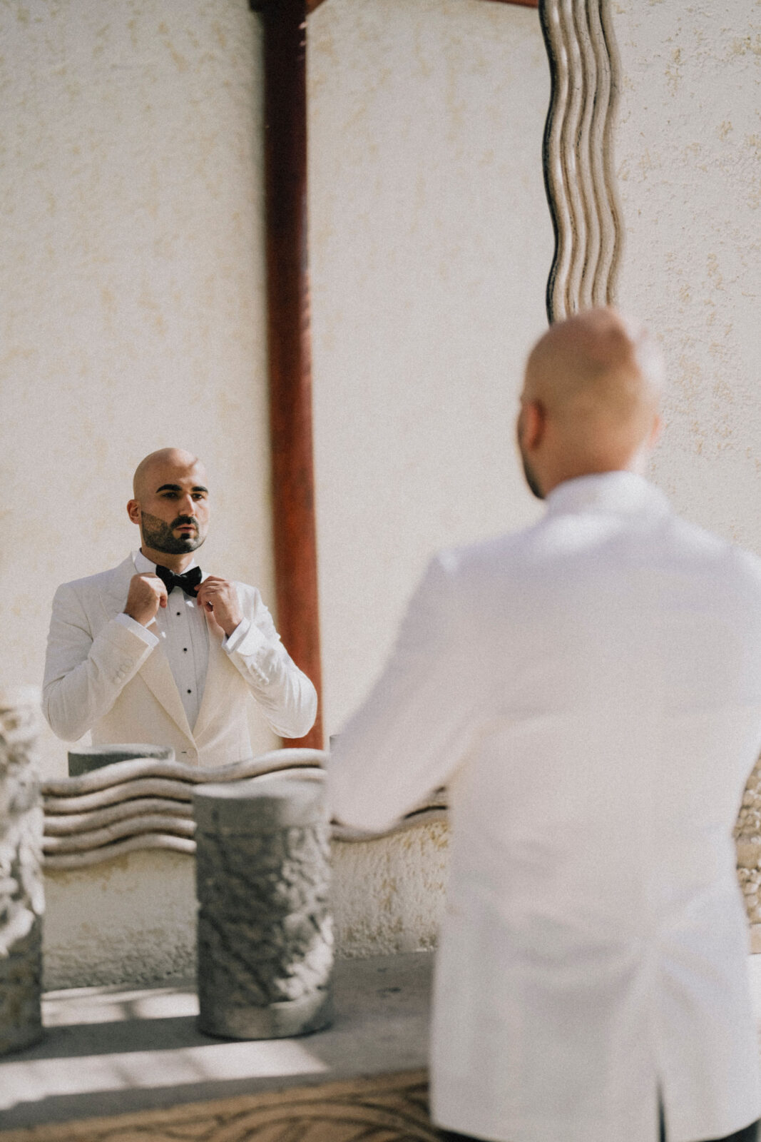 groom fixing his tie