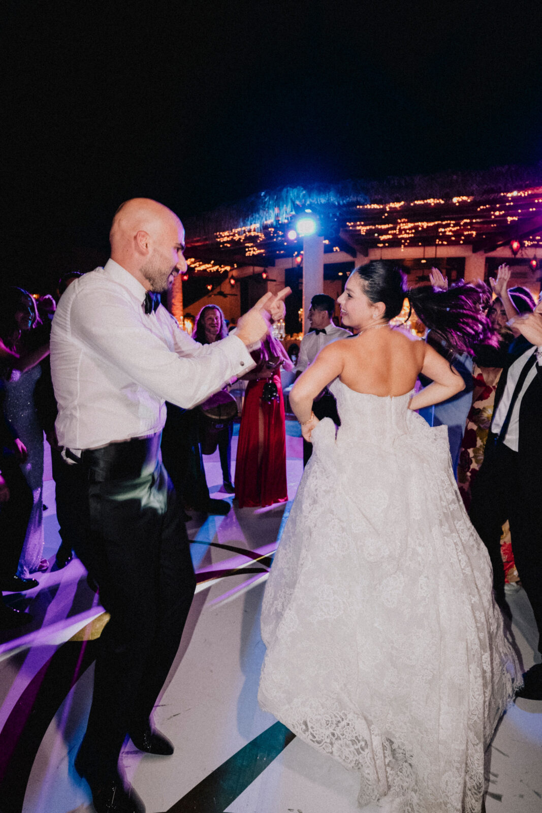 bride and groom dancing with friends