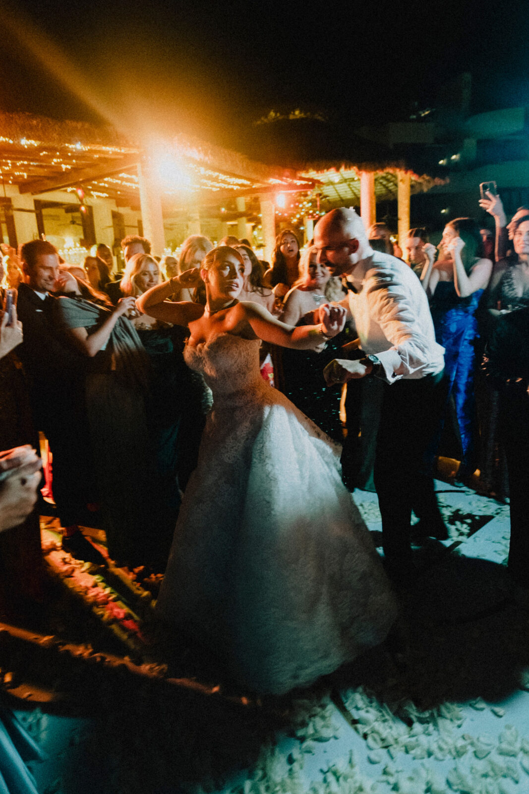 bride and groom dancing with friends