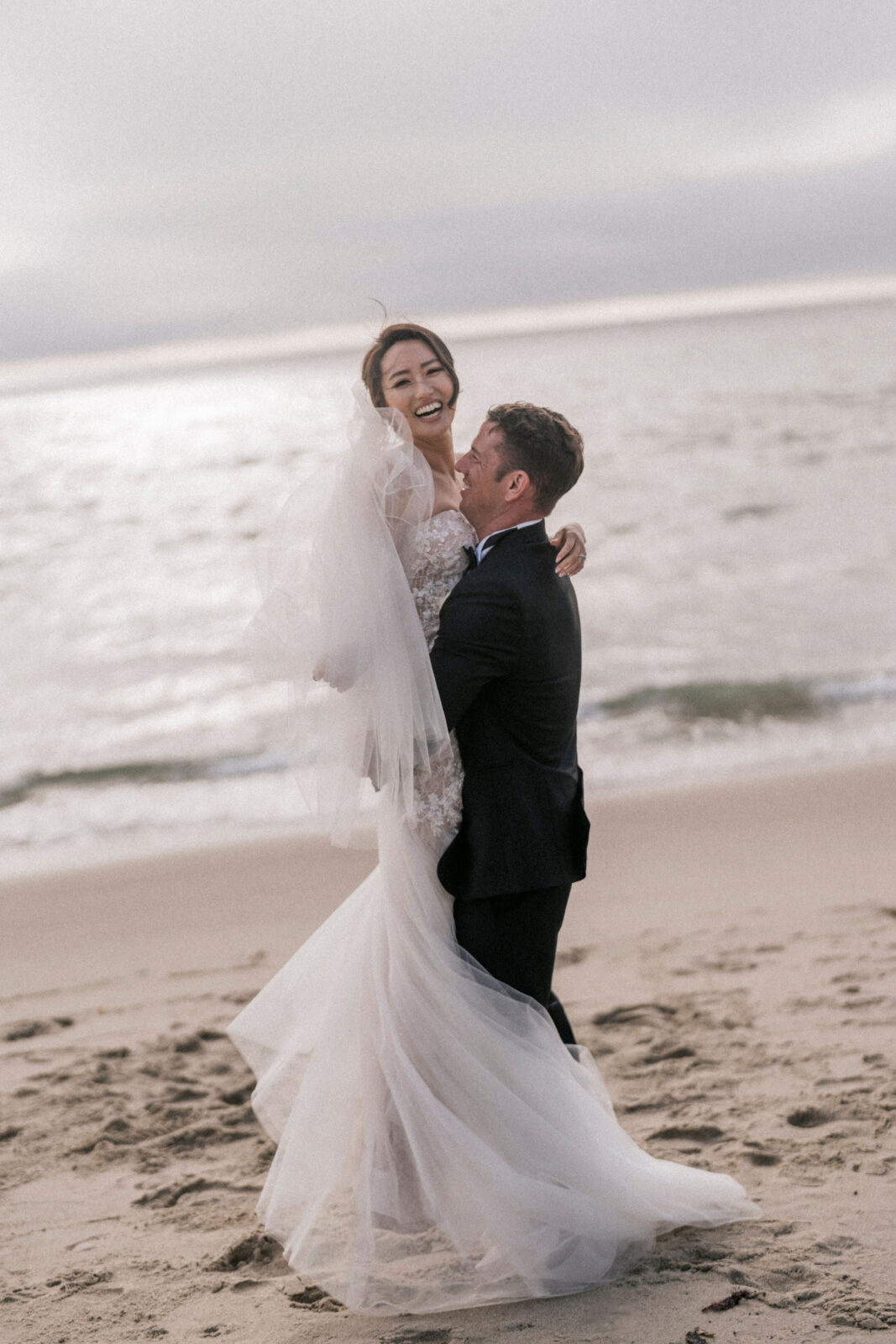 groom happily lifting bride