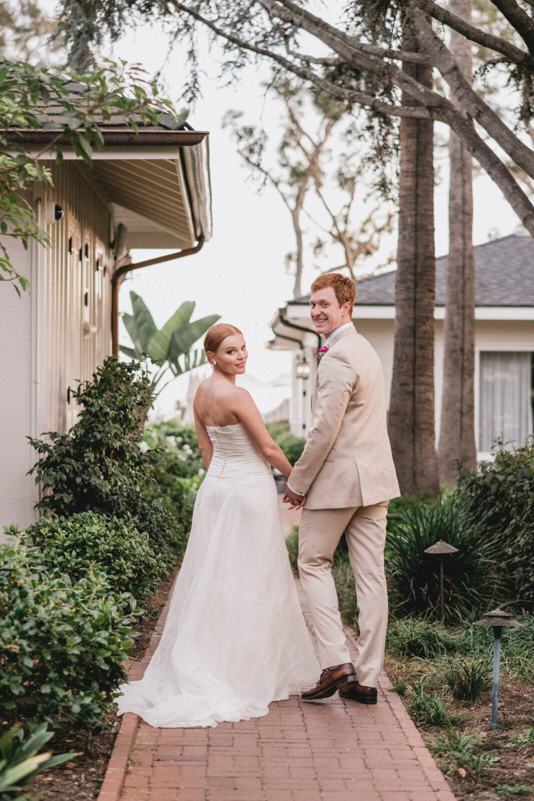 bride and groom holding hands