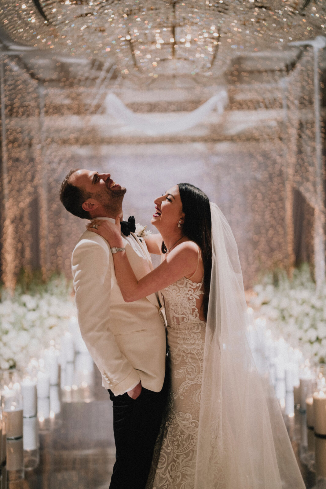 bride and groom laughing at each other