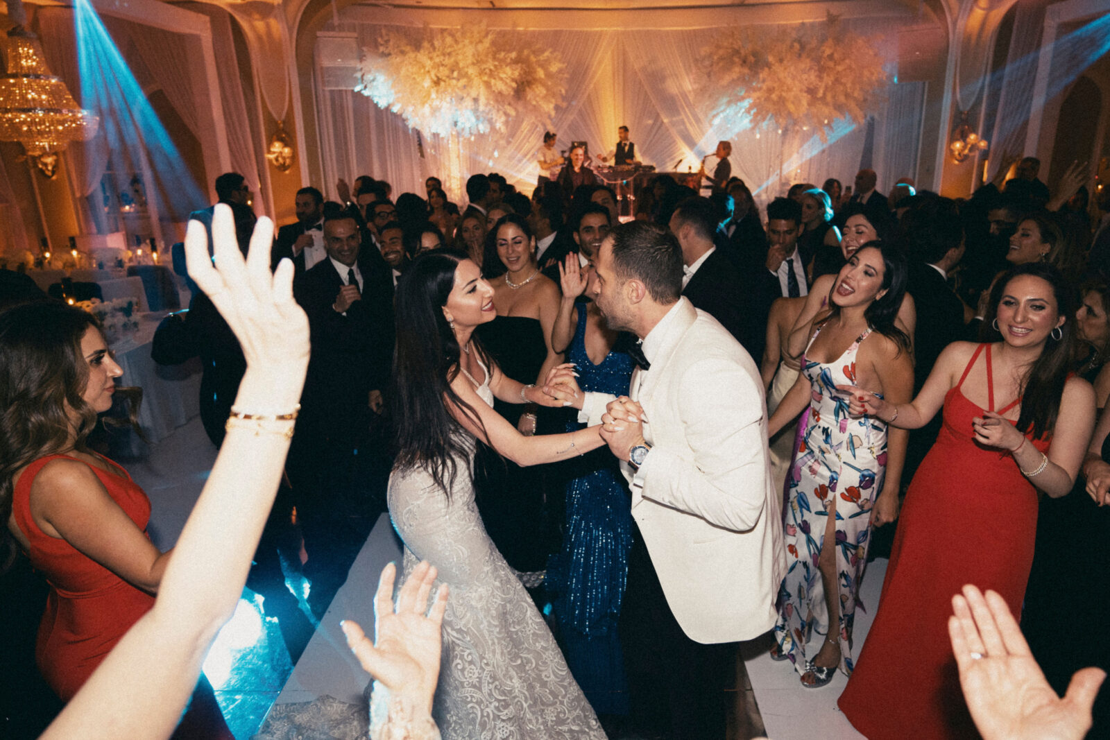 bride and groom dancing with friends