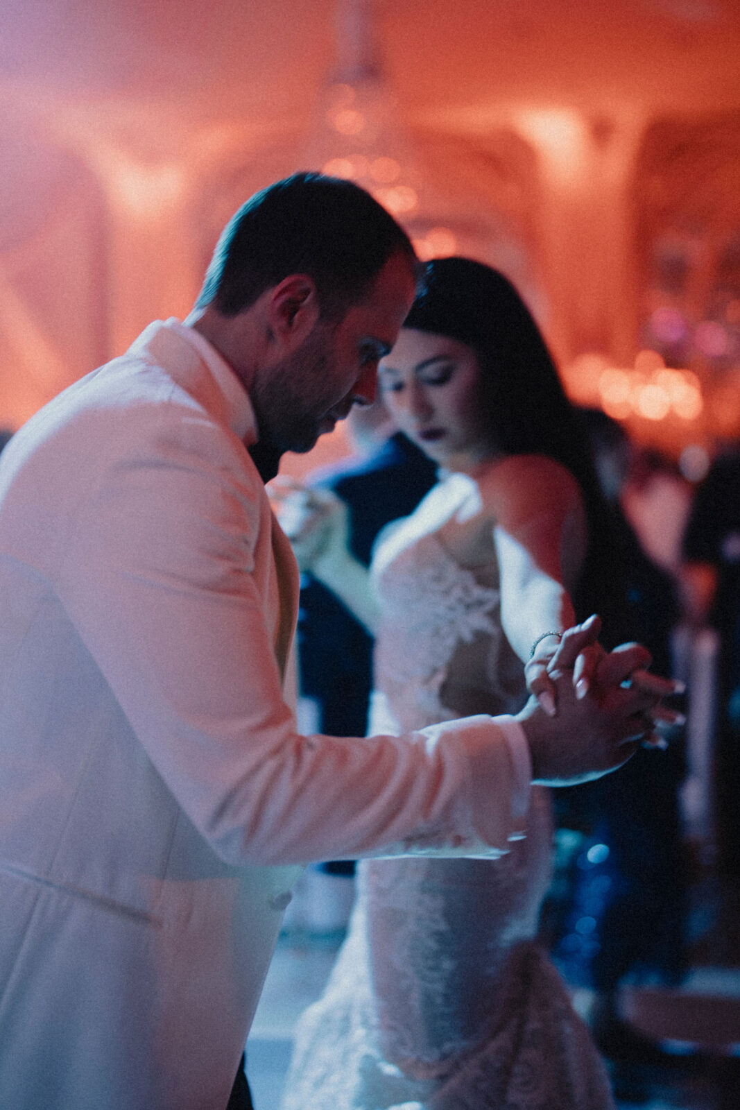 bride and groom holding hands while partying