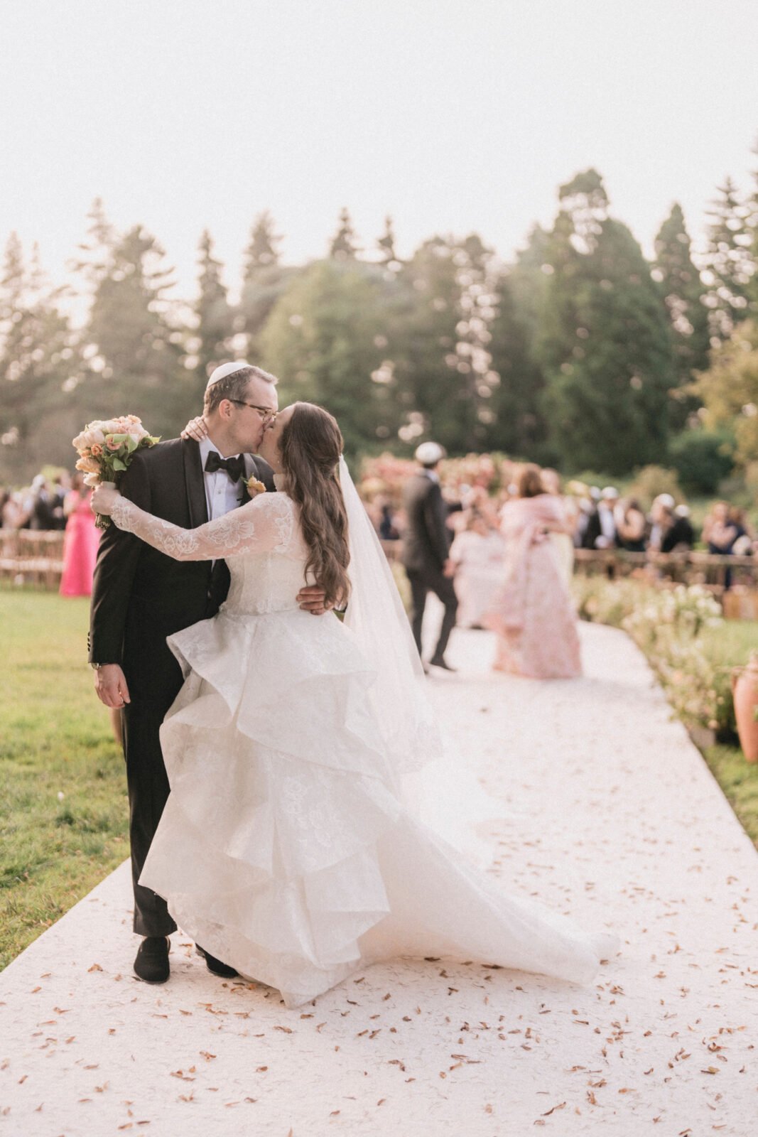 Bride and Groom exchanging kiss at the altar in Winterthur Garden