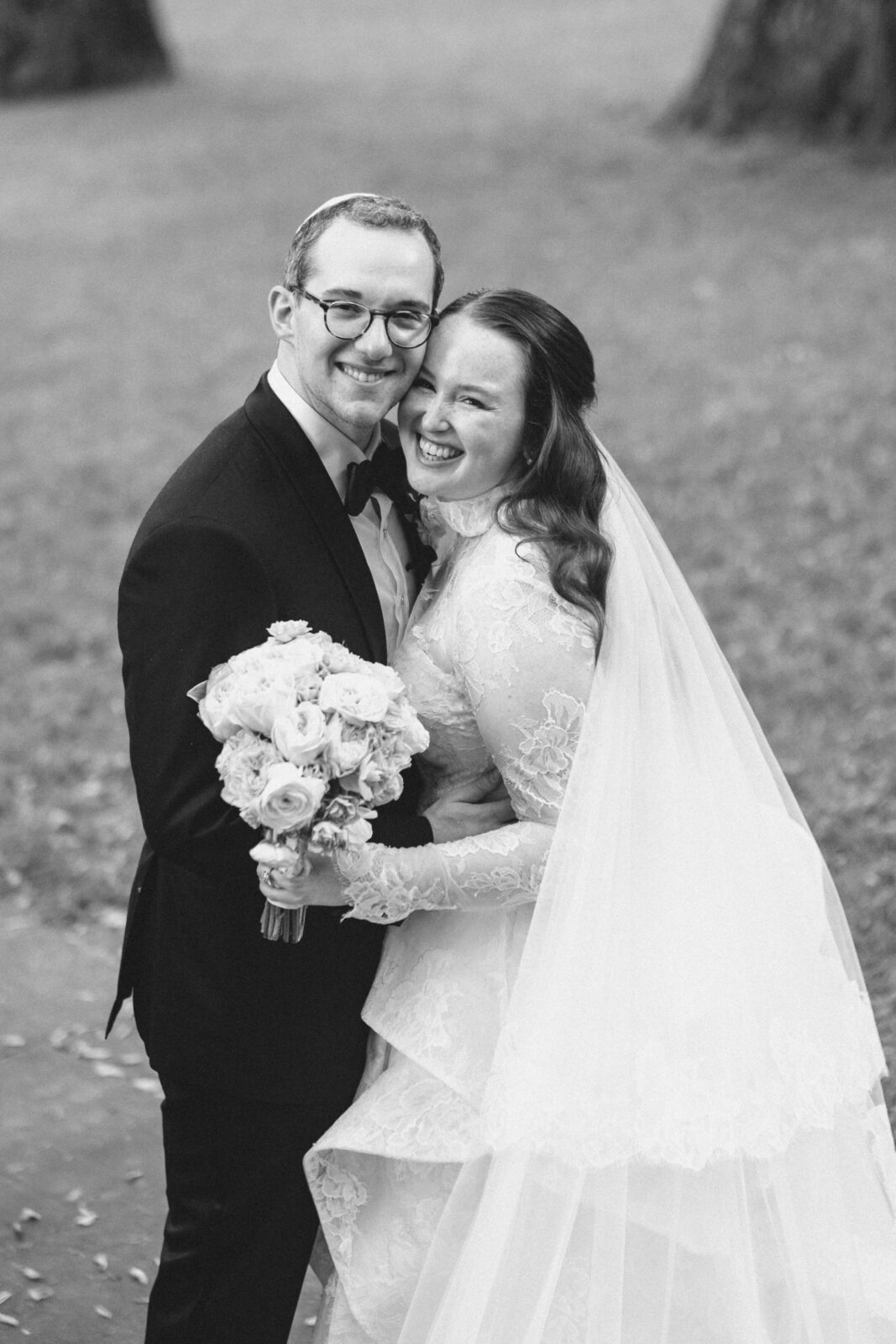 Black and white portrait of a smiling bride and groom at Winterthur Gardens