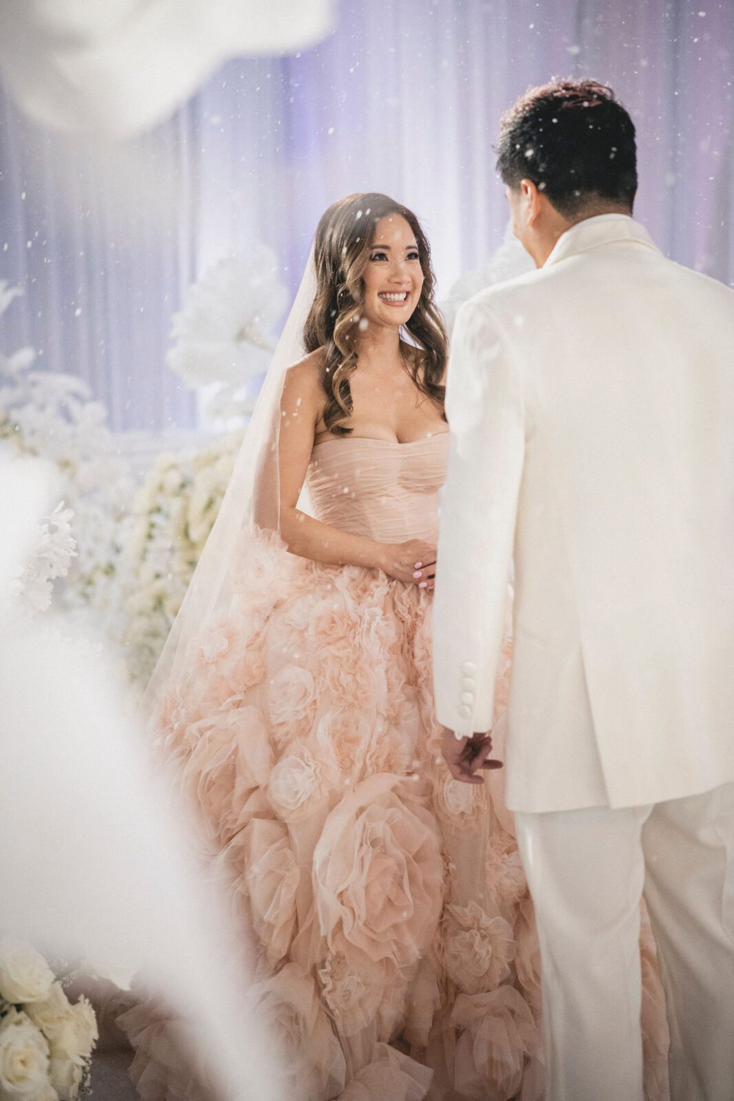 bride looking happy while looking at groom