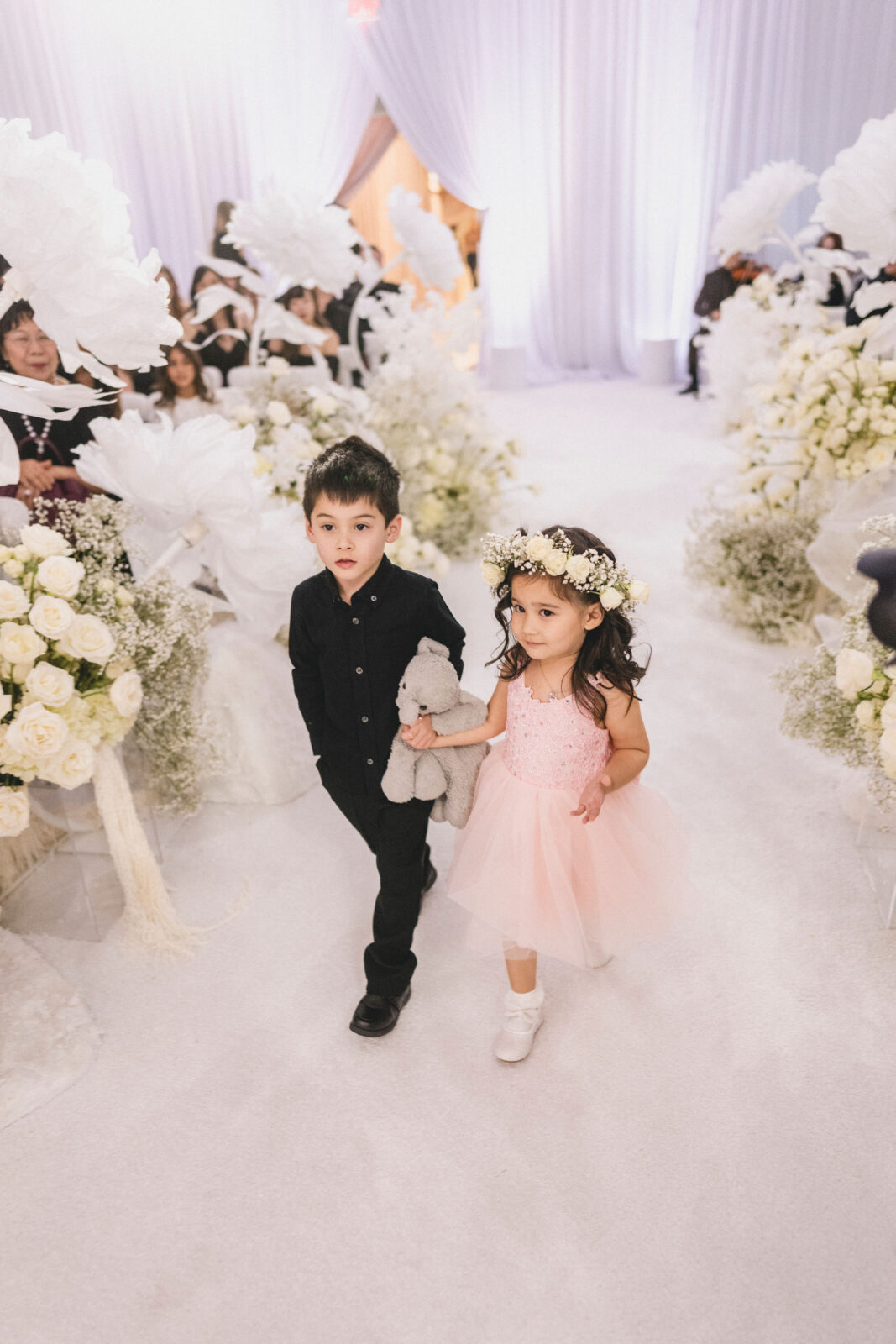 flower girl and ring bearer walking on the aisle