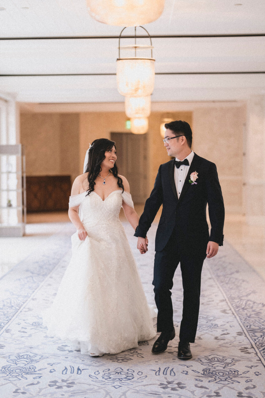 bride and groom holding hands