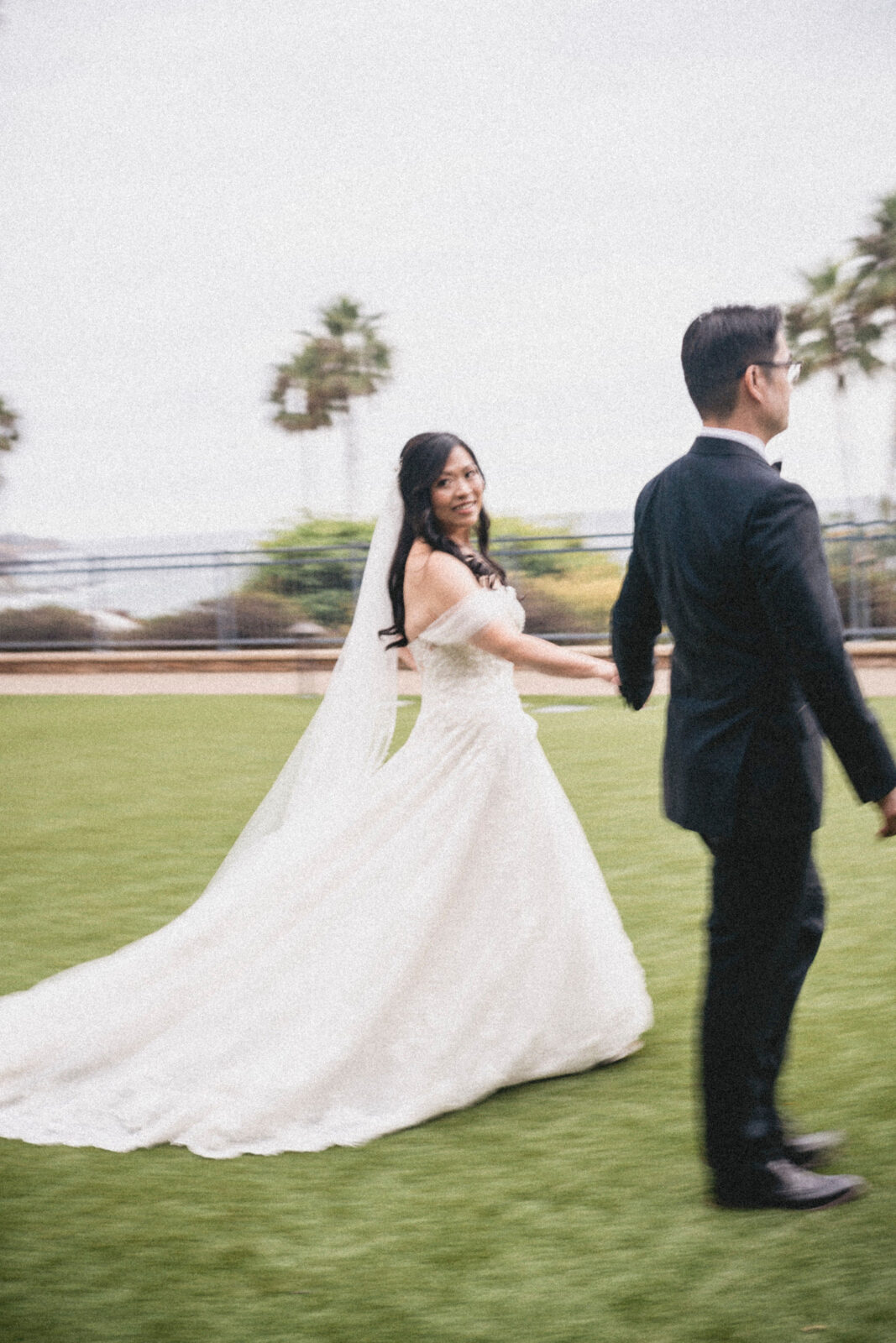 bride and groom holding hands