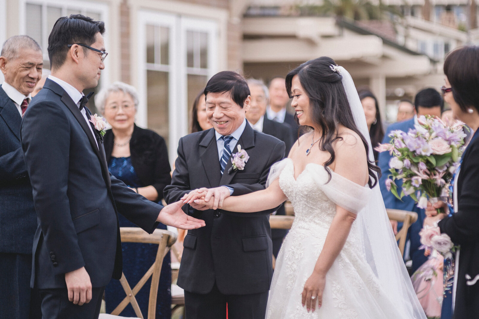 bride's father giving his daughter's hand at the altar