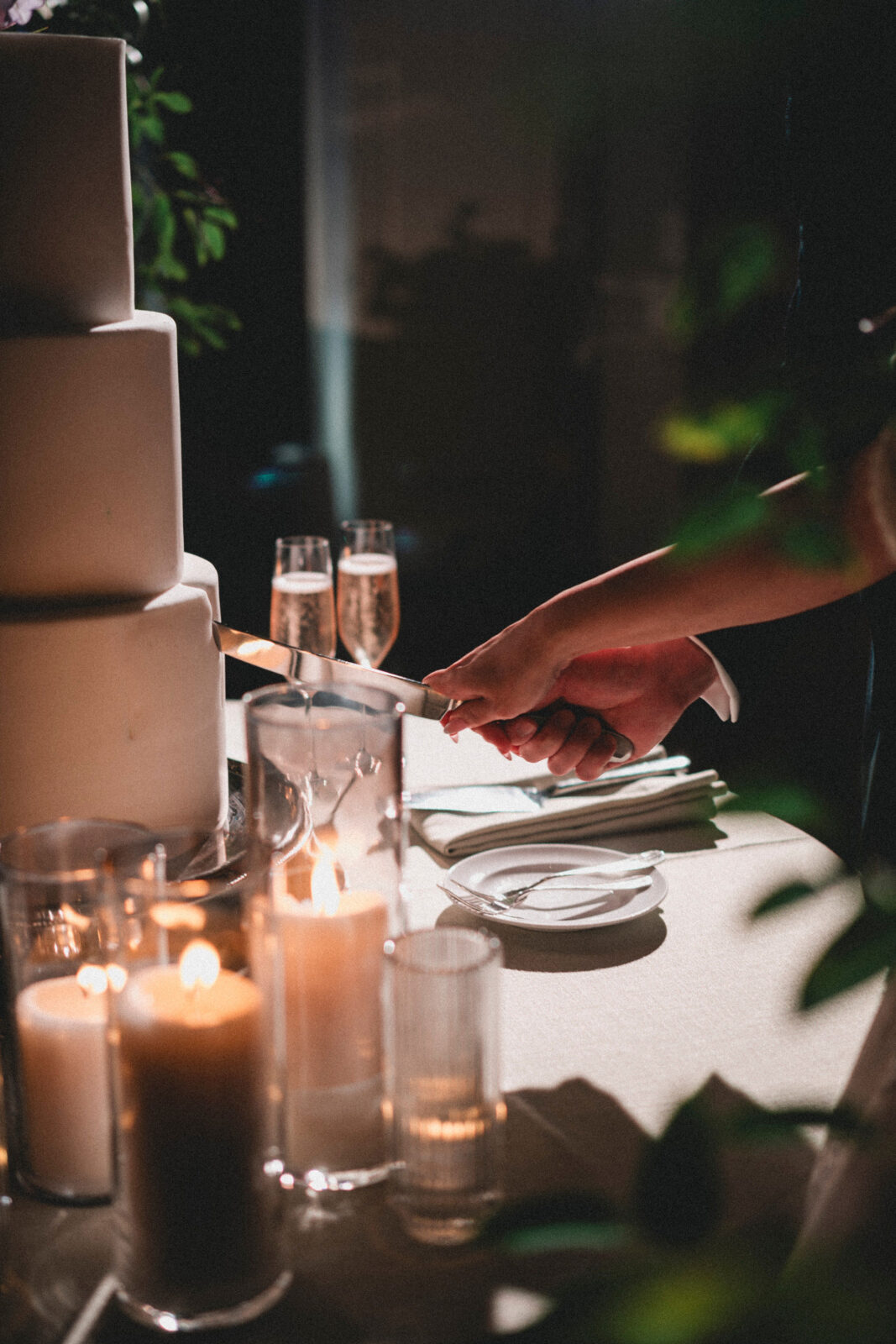 bride and groom slicing cake