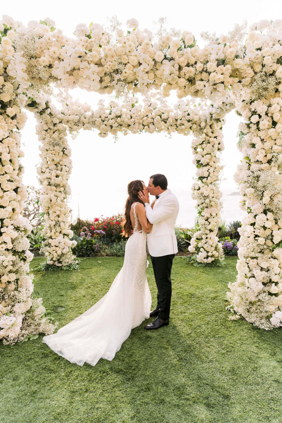 bride and groom exchanging kiss at the altar