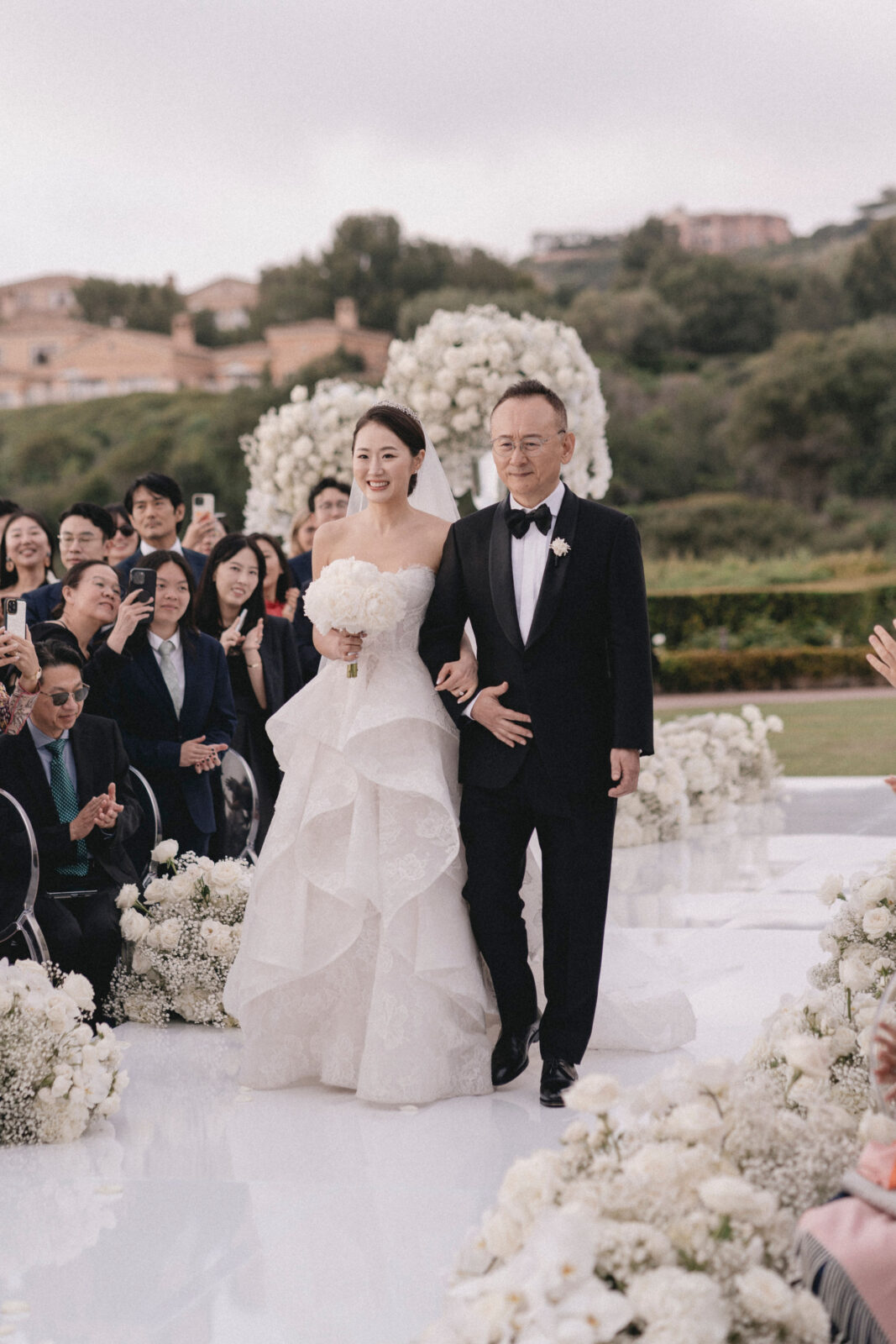 bride walking in the aisle with her father