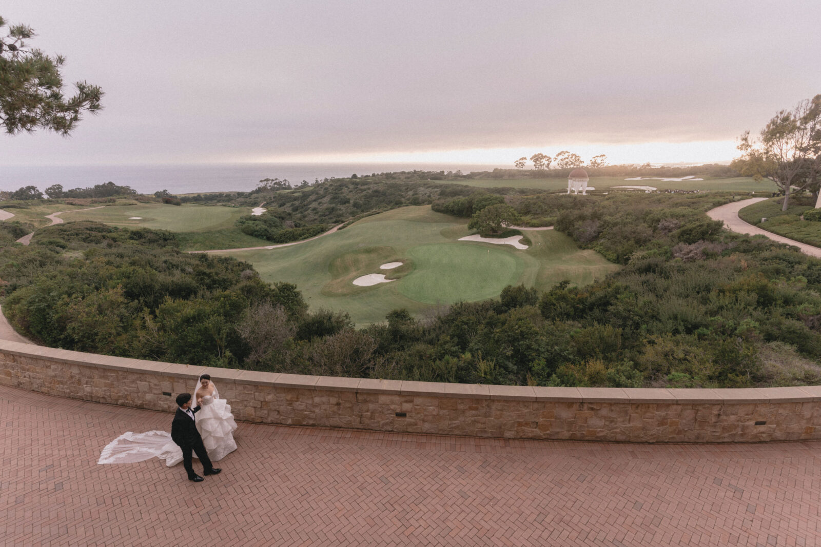 bride and groom with Pelican Resort in Newport Beach, California view