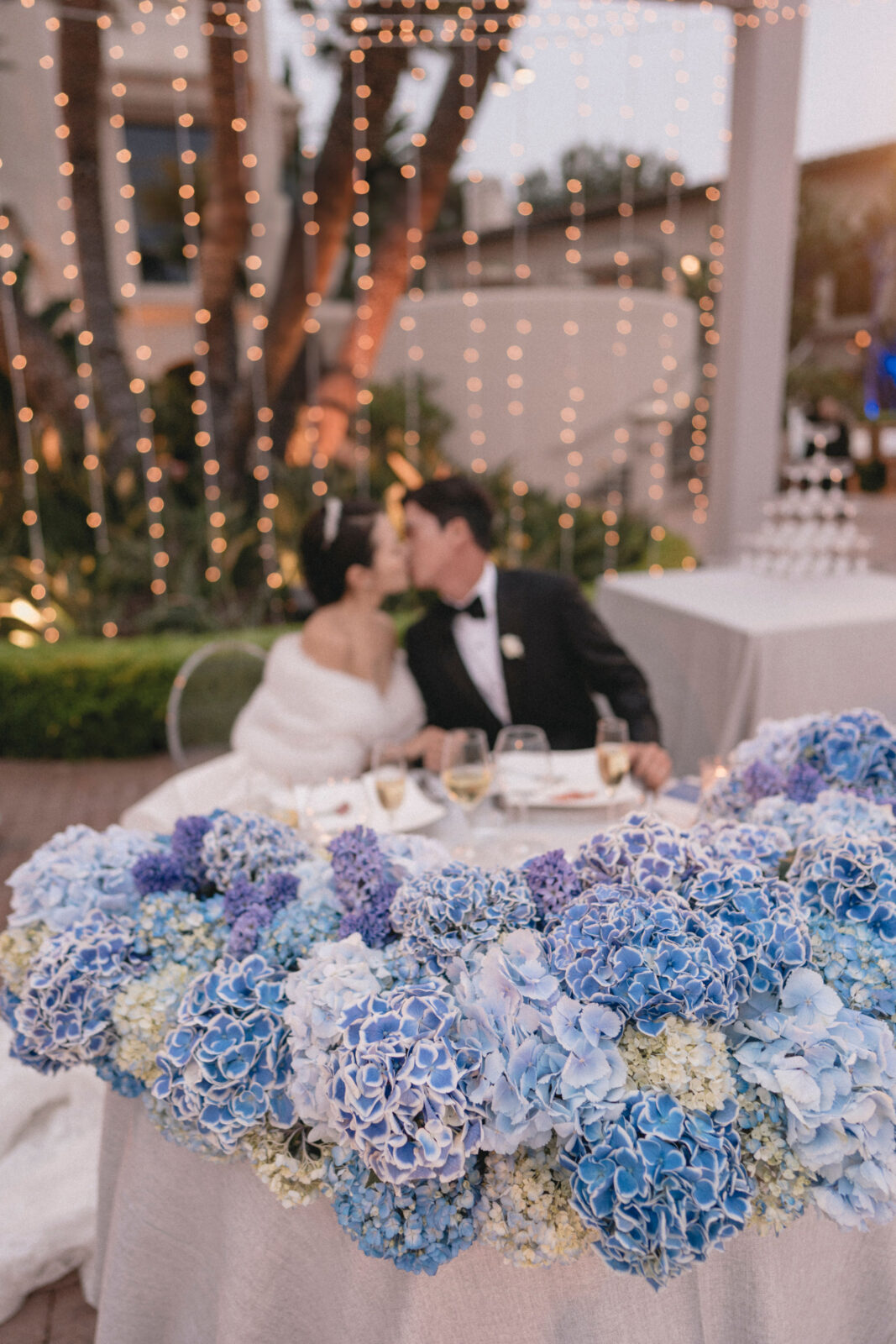 bride and groom kissing at background