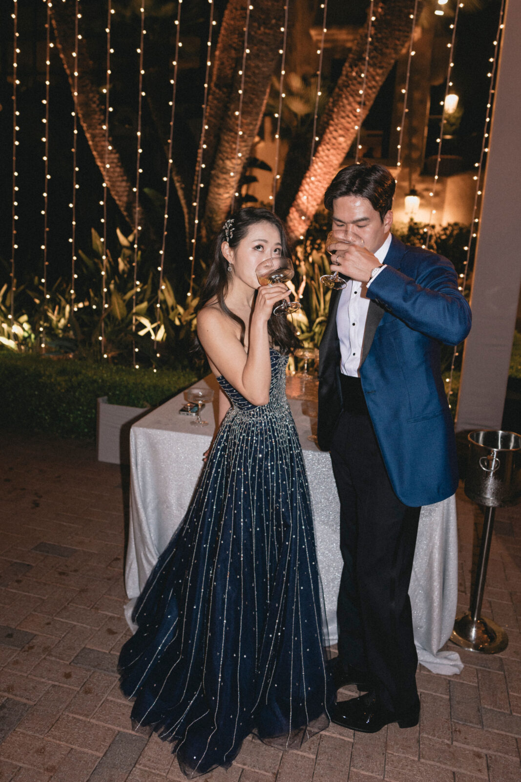 bride and groom happily drinking wines