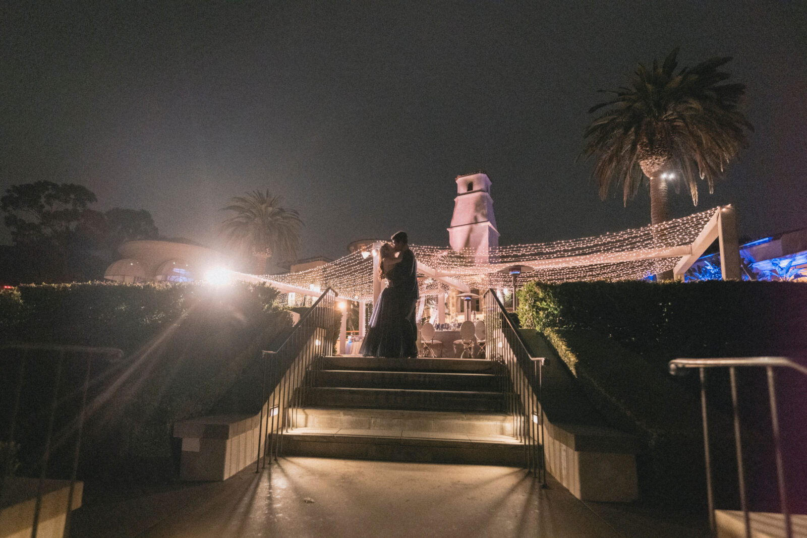 bride and groom kissing at night