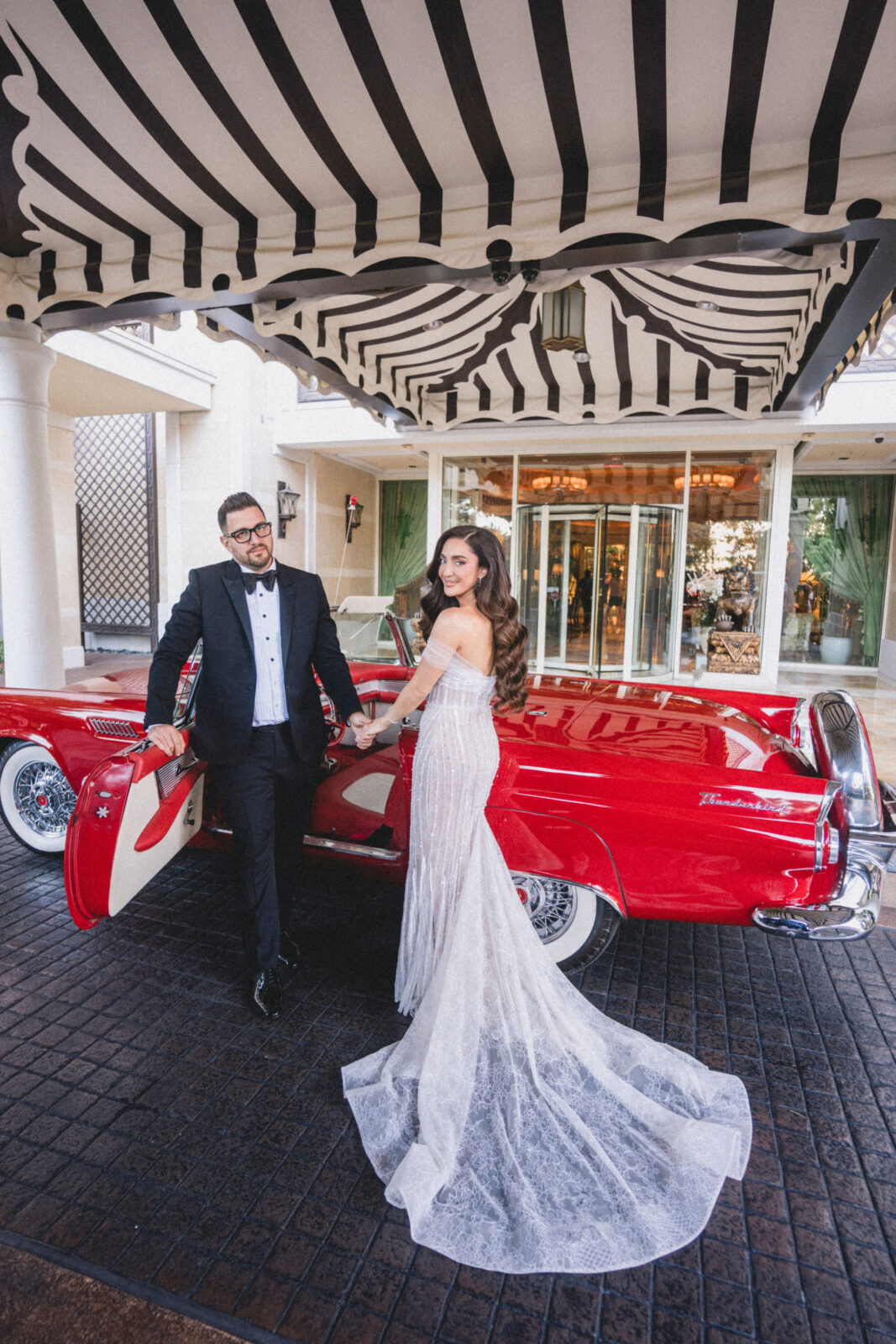 bride and groom going and a red sportscar