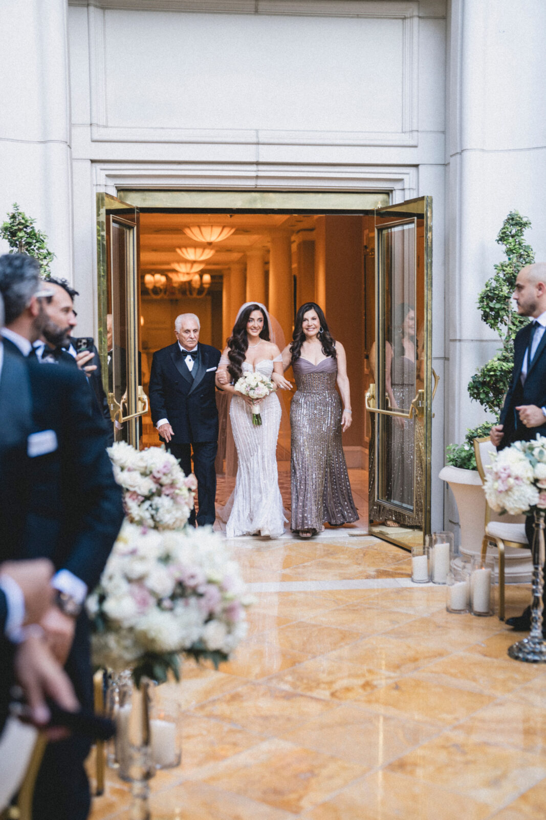 bride and parents walking on the aisle