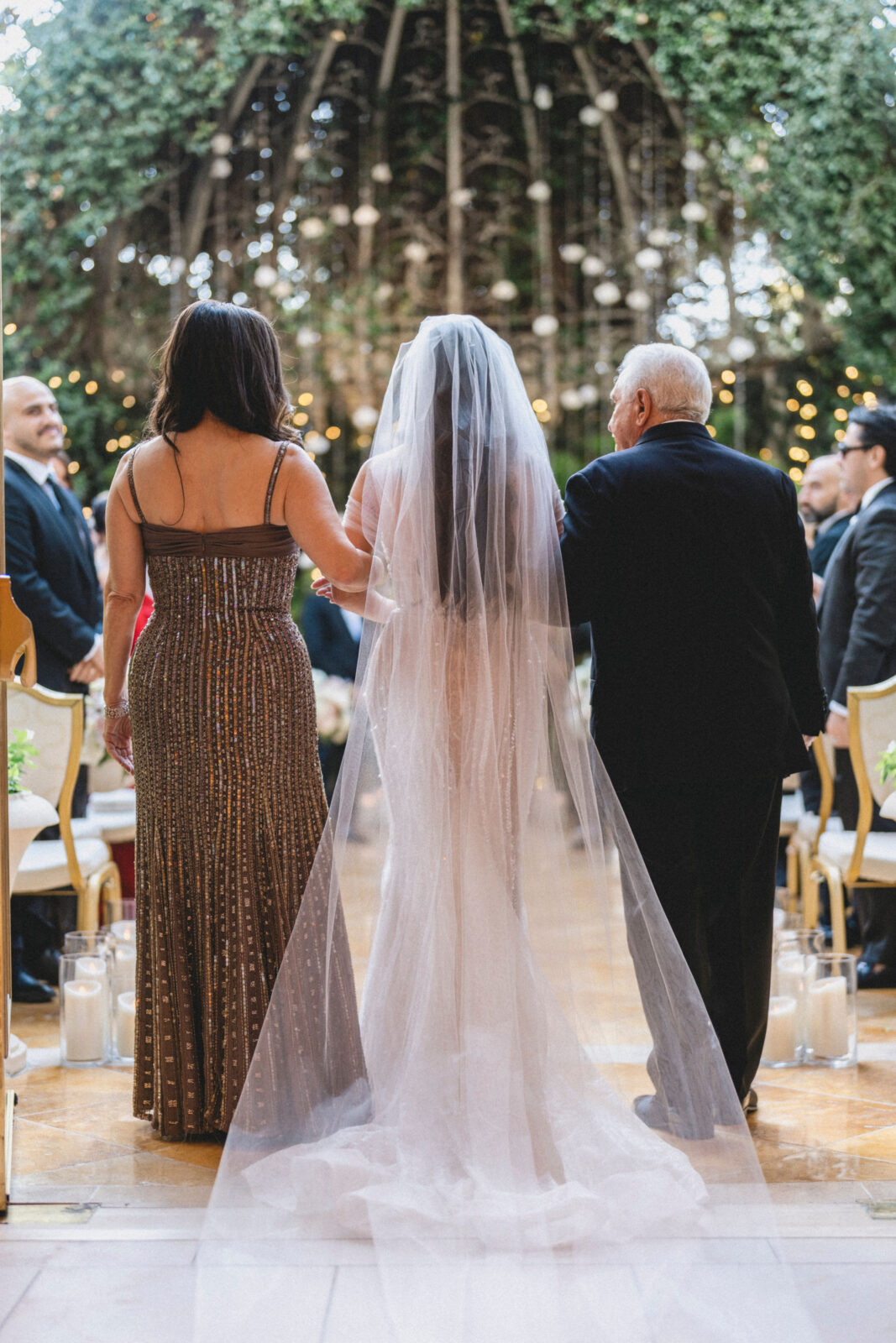 bride and parents walking on the aisle