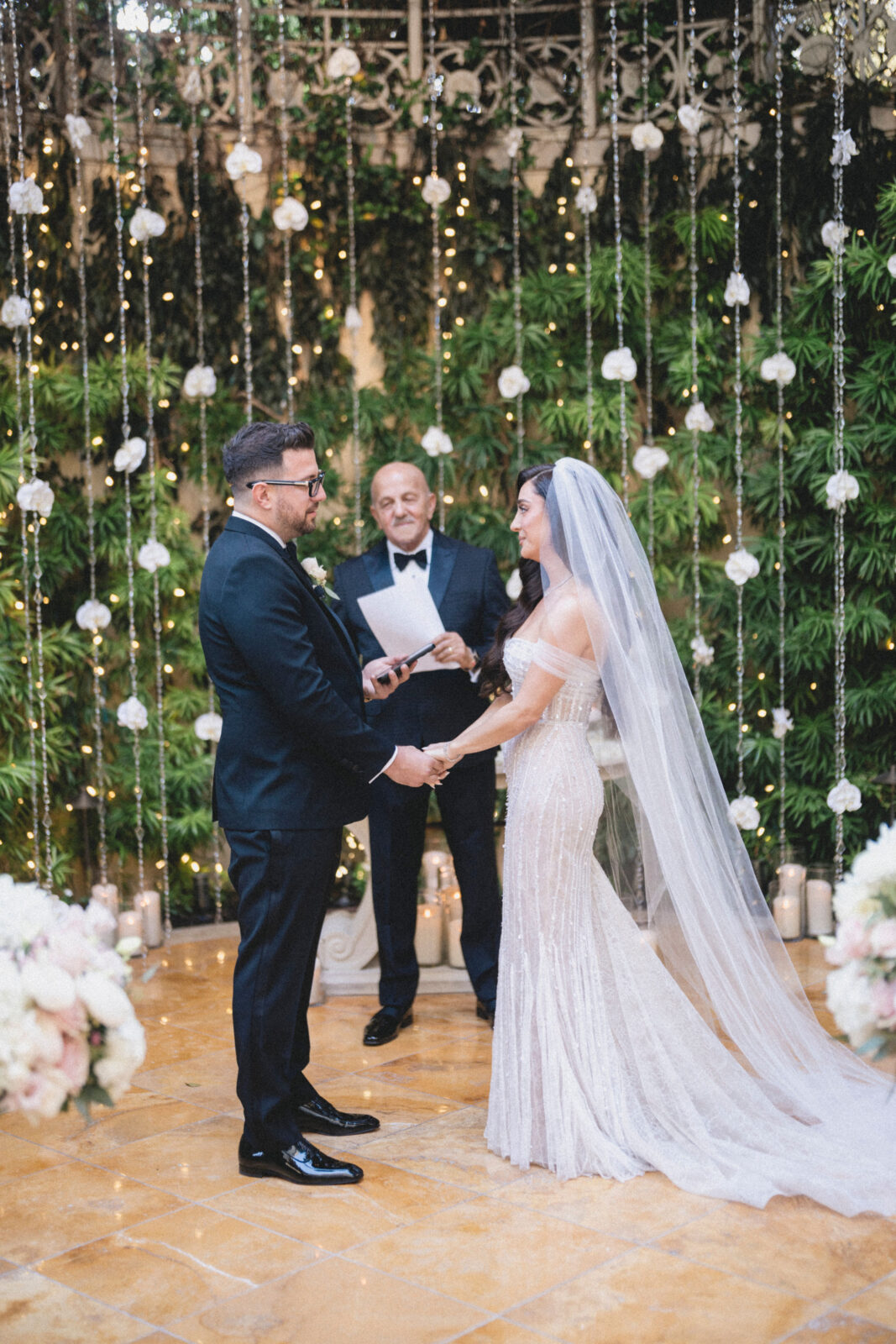 bride and groom exchanging vows at the altar