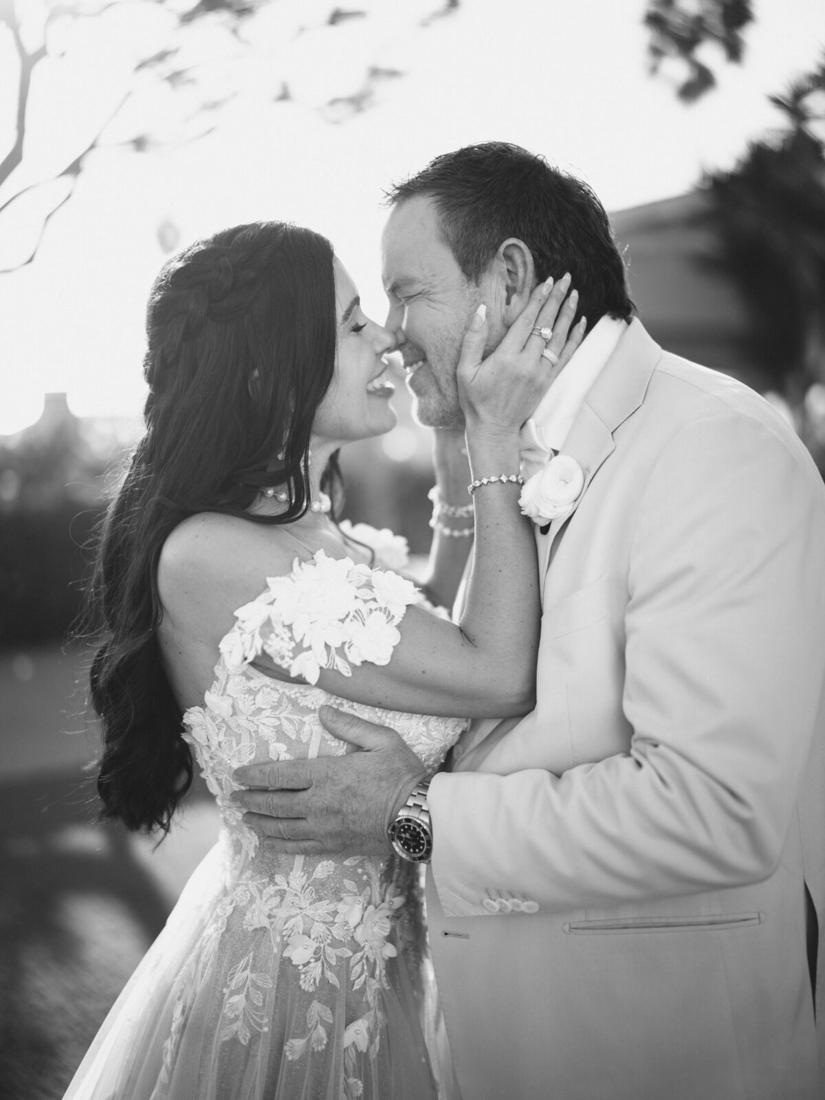 Bride holding groom's face