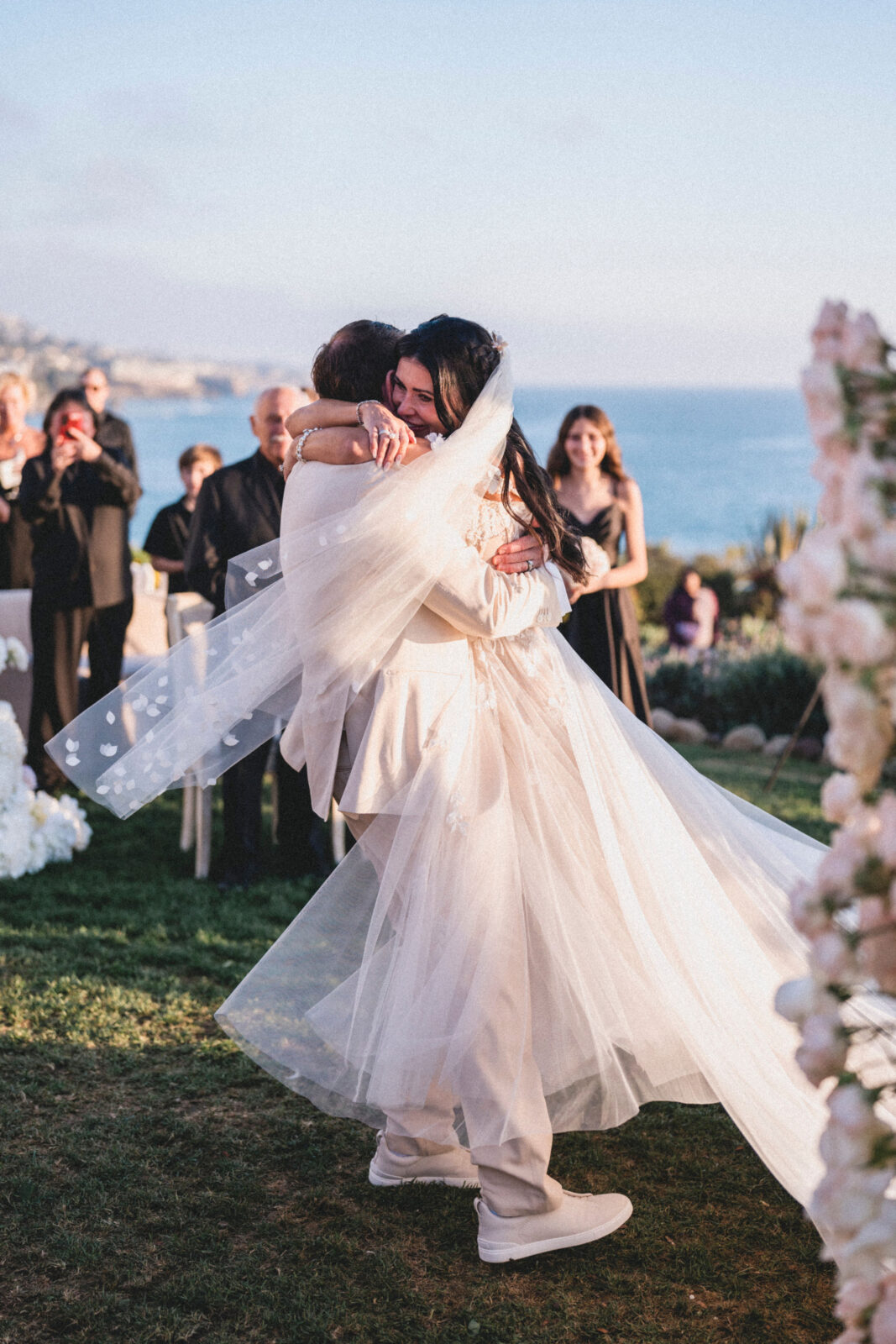 bride and groom hugging each other after ceremony