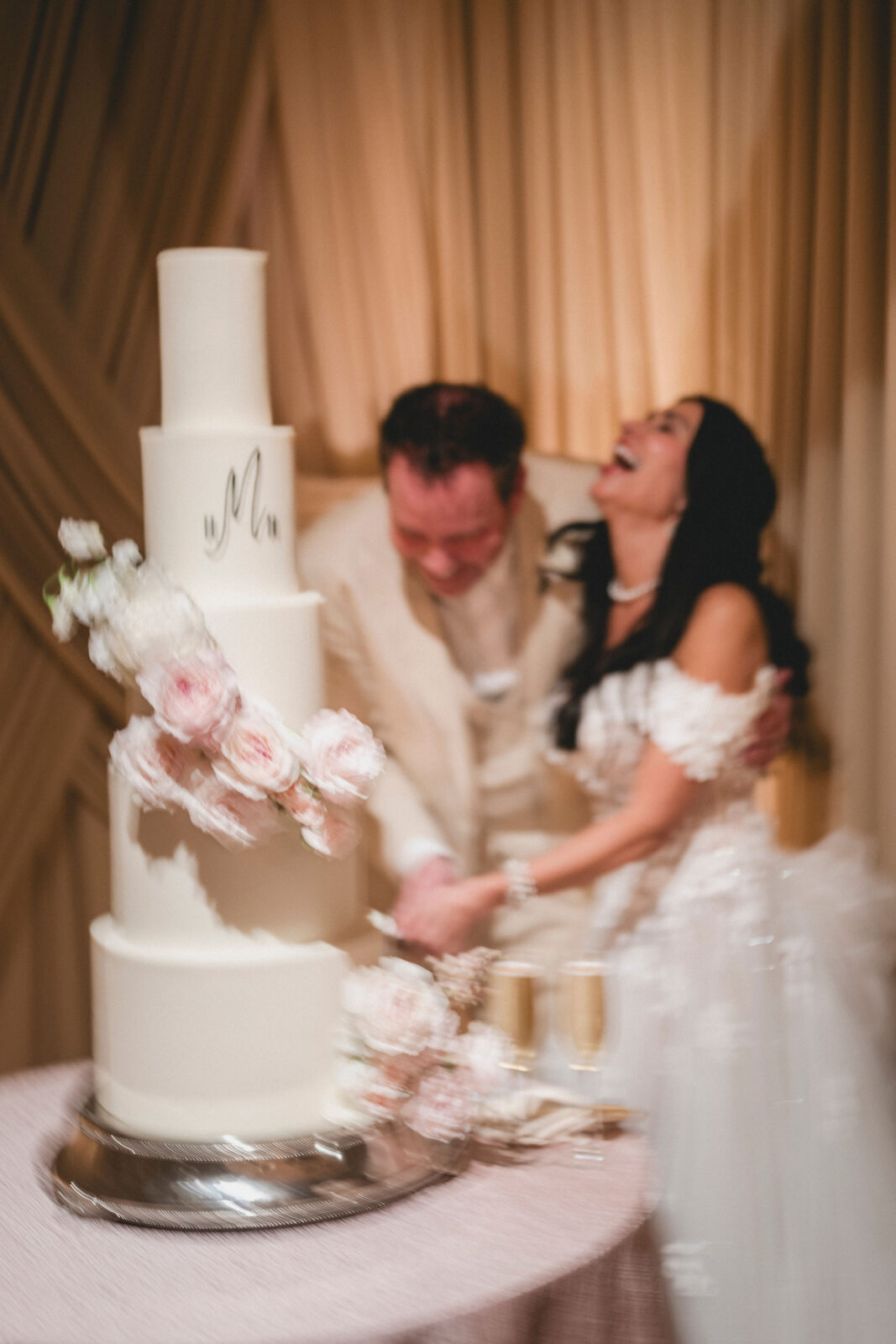 bride and groom happily cutting the cake