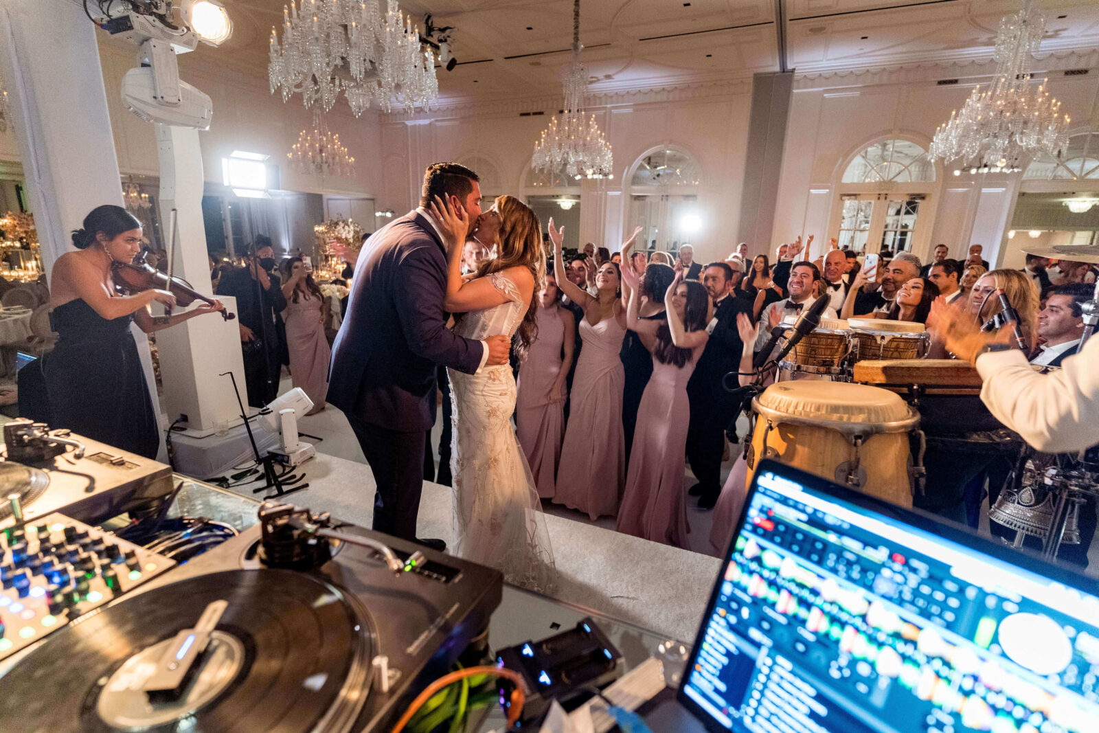 bride and groom kissing onstage